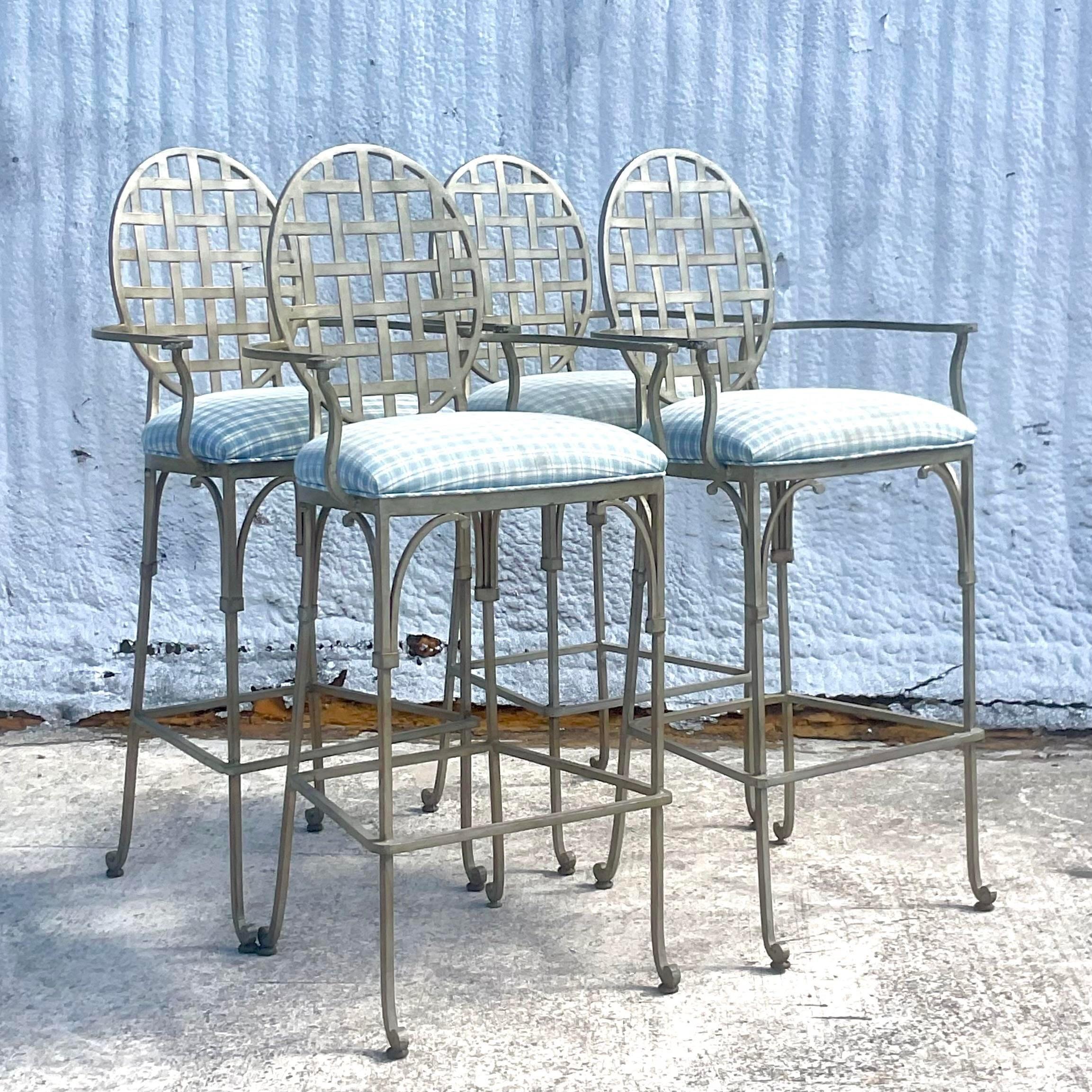 A fantastic set of four vintage Coastal barstools. A chic brushed wrought iron with a charming trellis design. Tall and sturdy. Acquired from a Palm Beach estate.