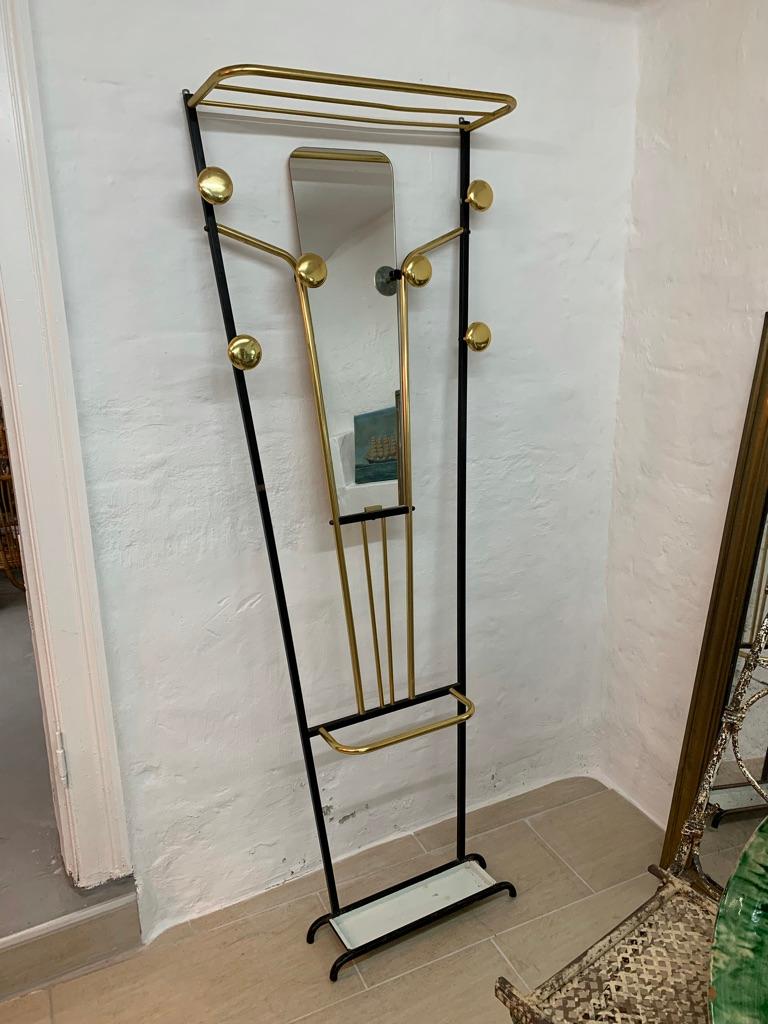 Elegant and practical vintage French coat stand with mirror and umbrella stand. Black and white painted metal and brass.