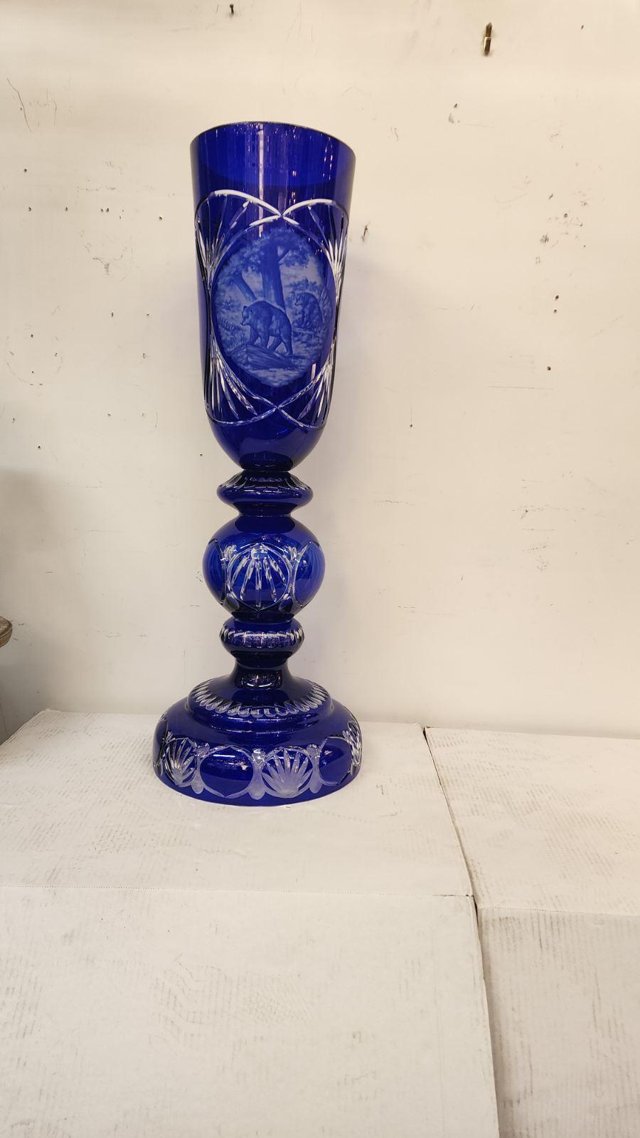 Bohemian style vases colored cobalt blue, made from art glass with intricate carvings. With pictures of bears. 