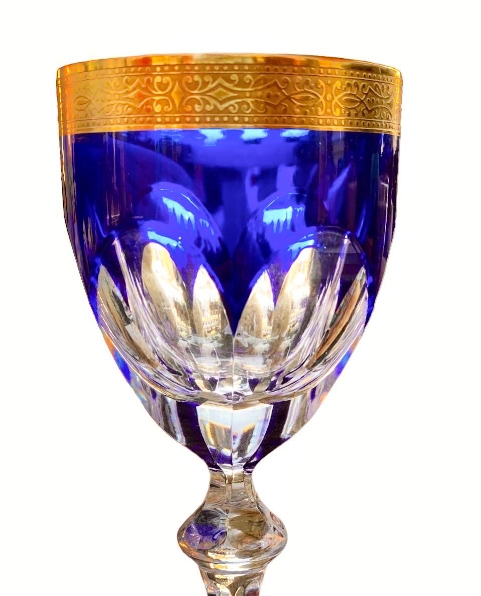 Lovely matching set of two antique cobalt blue and gold cased crystal goblets. This set has a nice crisp cased and cut to clear cobalt blue bowl with a cut knob stem as well. The 24 karat gold band measures an half inch and it is acid etch for