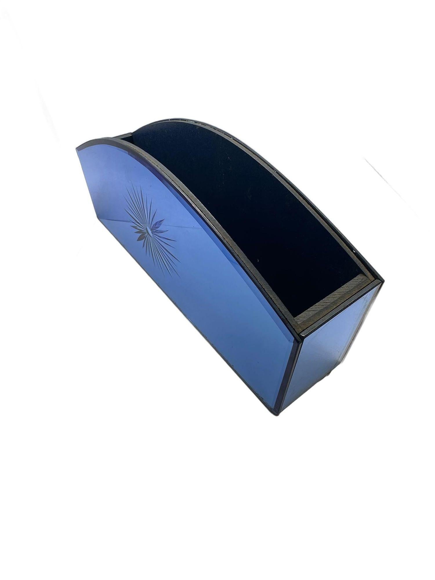 A vintage bold cobalt blue glass mail organizer with an etched sunburst design is both elegant and functional. The bright deep blue hue adds sophistication, while the sunburst design adds a touch of warmth and style. It's a practical yet beautiful