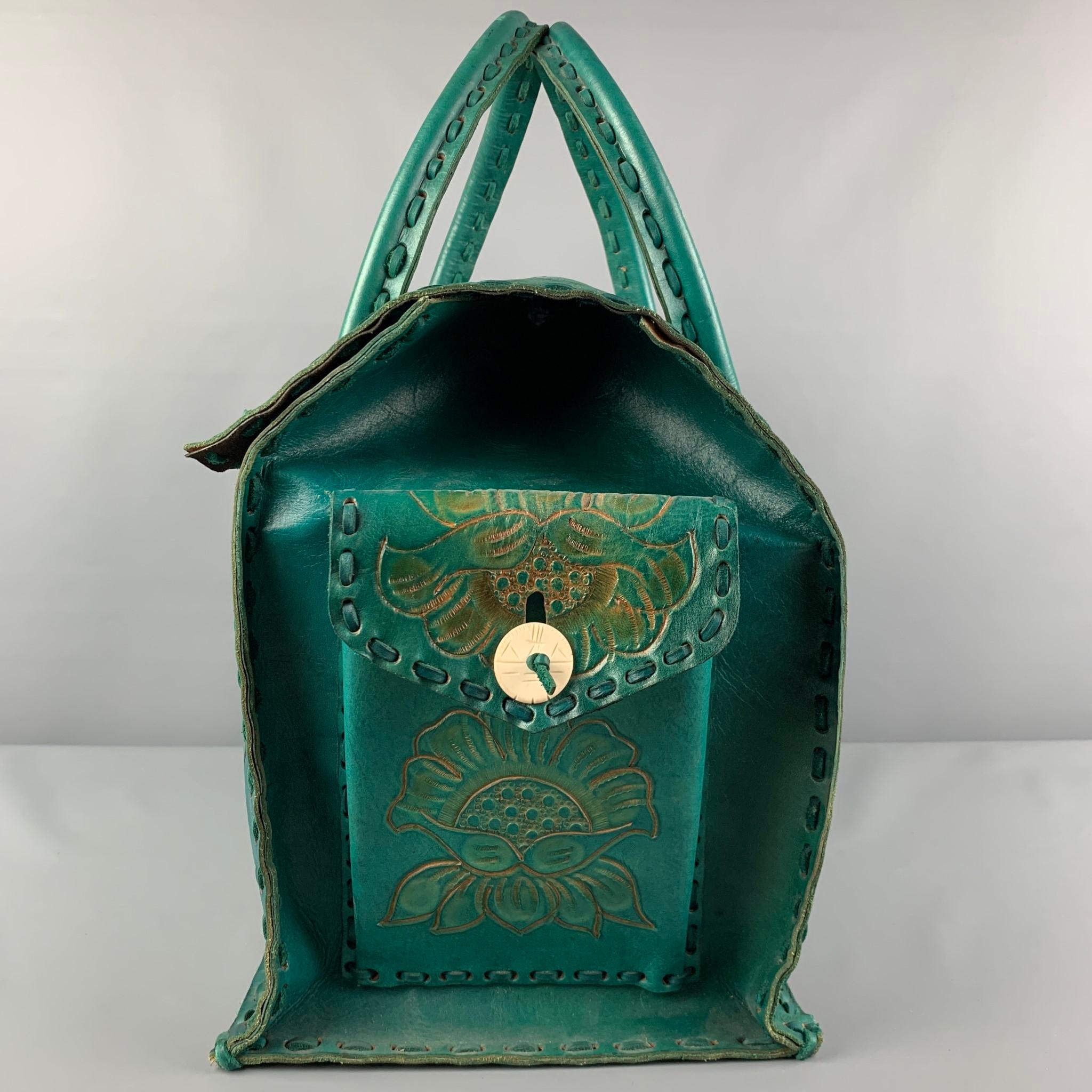 VINTAGE carry-on bag comes in a cobalt floral antique leather featuring top handles, side pockets details, inner slots, and a buttoned closure. 

Very Good Pre-Owned Condition.

Measurements:

Length: 17 in.
Width: 10 in.
Height: 14 in.
Drop: 10 in. 