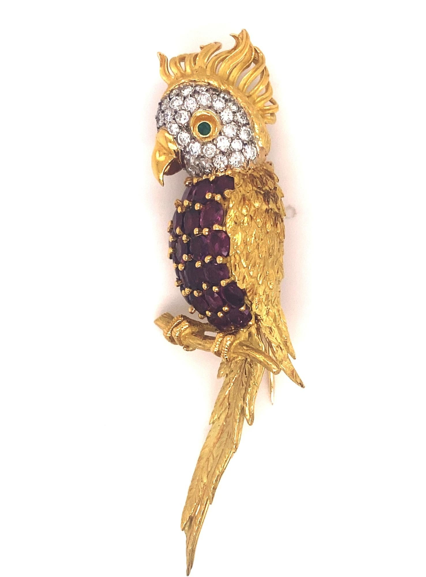 This is a beautiful large Cockatoo brooch with high quality rubies and diamonds. The feathers are finely detailed amazing gold work. Brooch containing 22 round and oval cut rubies weighing approximately 6.00 carats total great clarity and color.