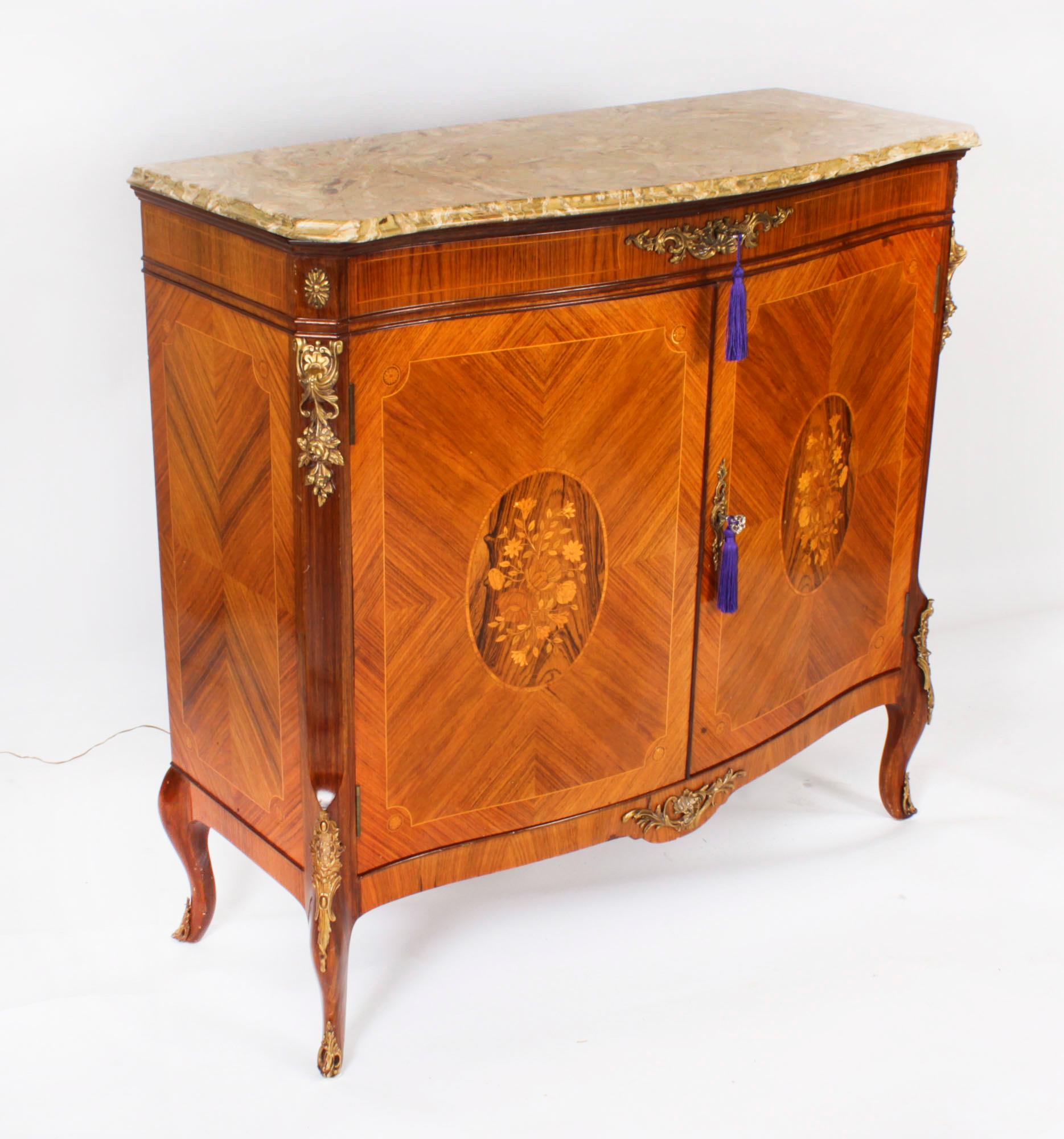 This is a fantastic vintage wood cocktail cabinet with fabulous ormolu mounts, exquisite floral marquetry decoration and an elegant 'Marmo di Brescia' marble top, circa 1950 in date and by the renowned makers of bespoke furniture, Epstein Bros.

The