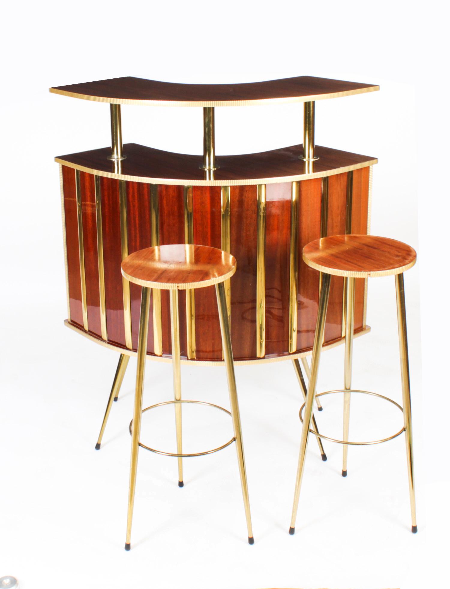 This is a large fantastic Italian Mid-Century Modern mahogany and ormolu mounted mini-bar with two stools, circa 1940's in date.

The botanical name for the mahogany on this bar and stools is made of Swietenia Macrophylla and this type of mahogany