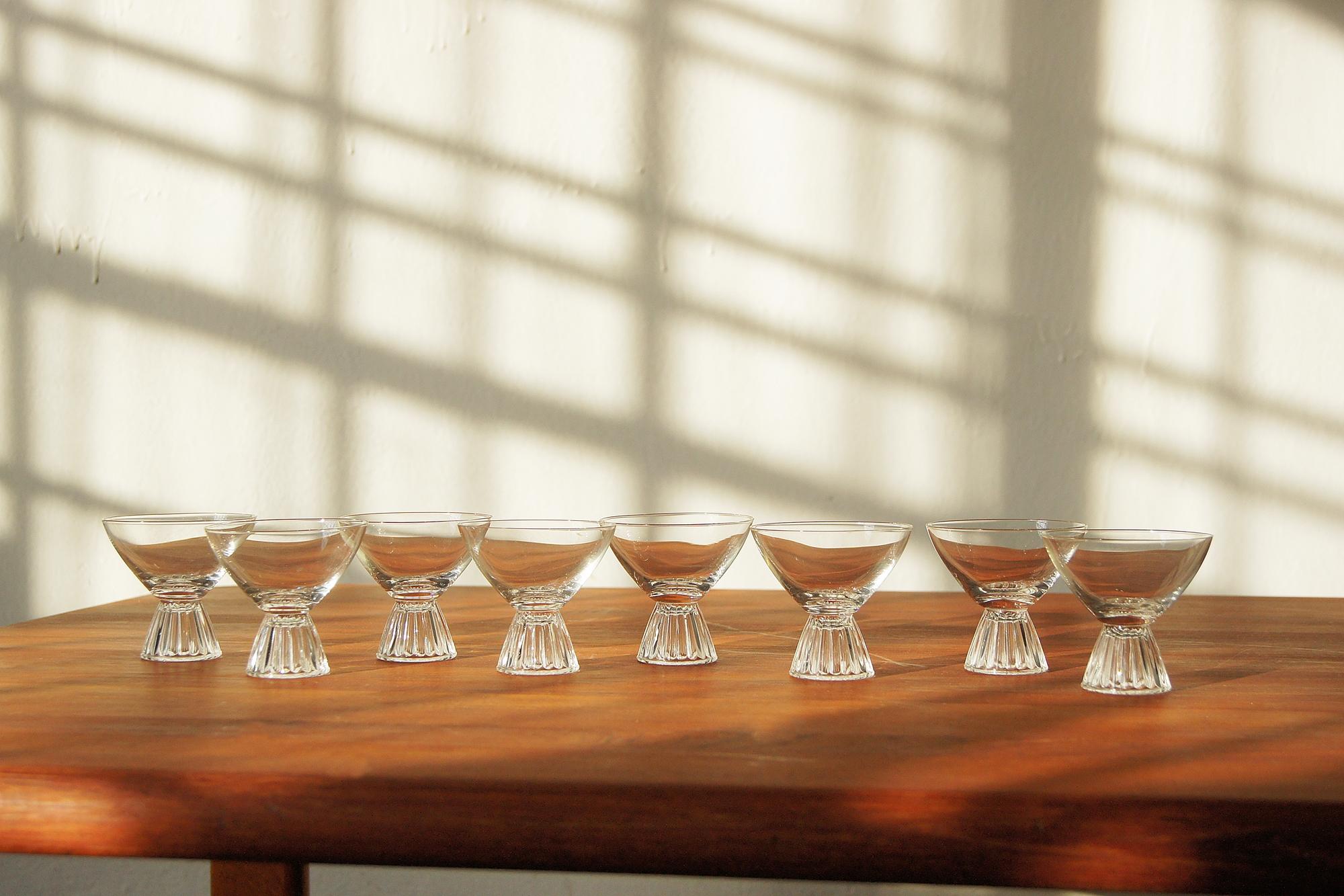 A stunning set of eight crystal cocktail glasses in the style of Paden City from the 1950s.  

Each glass features a delicately rounded bowl that subtly widens towards the top, emphasizing the elegance of the glass. The slender proportions and