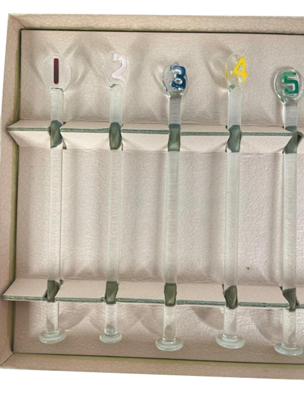 Boxed set of glass cocktail muddlers of clear glass with a disk at the base and a paddle-form top with a raised molded number, numbered 1 to 8 with each number painted a different color in order for guests to keep track of their drink.
