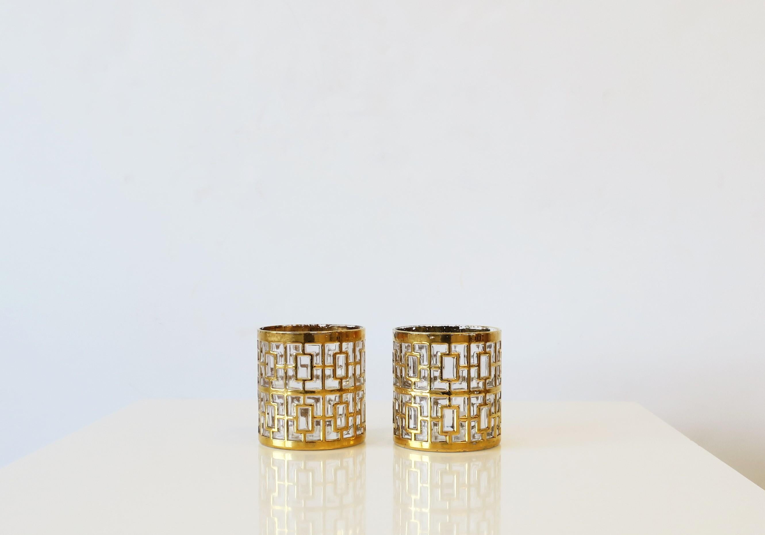 A beautiful and chic set of two (2) vintage small cocktail rocks' glasses in the Hollywood Regency style by Imperial Glass Co., circa 1960s, USA. Glasses have a 22-karat gold-plate overlay on clear glass in the 'Shoji' screen pattern, which was