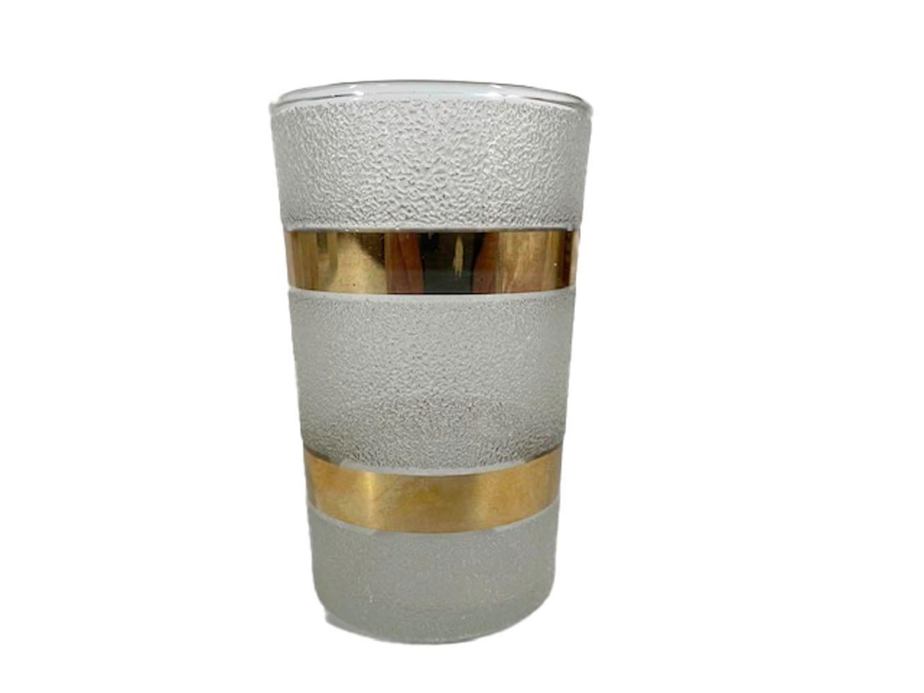 Art Deco cocktail shaker and four cocktail glasses having two wide bands of 22k gold on a textured frosted ground. Most likely Macbeth-Evans after it was acquired by and operated as a division of Corning Glass.