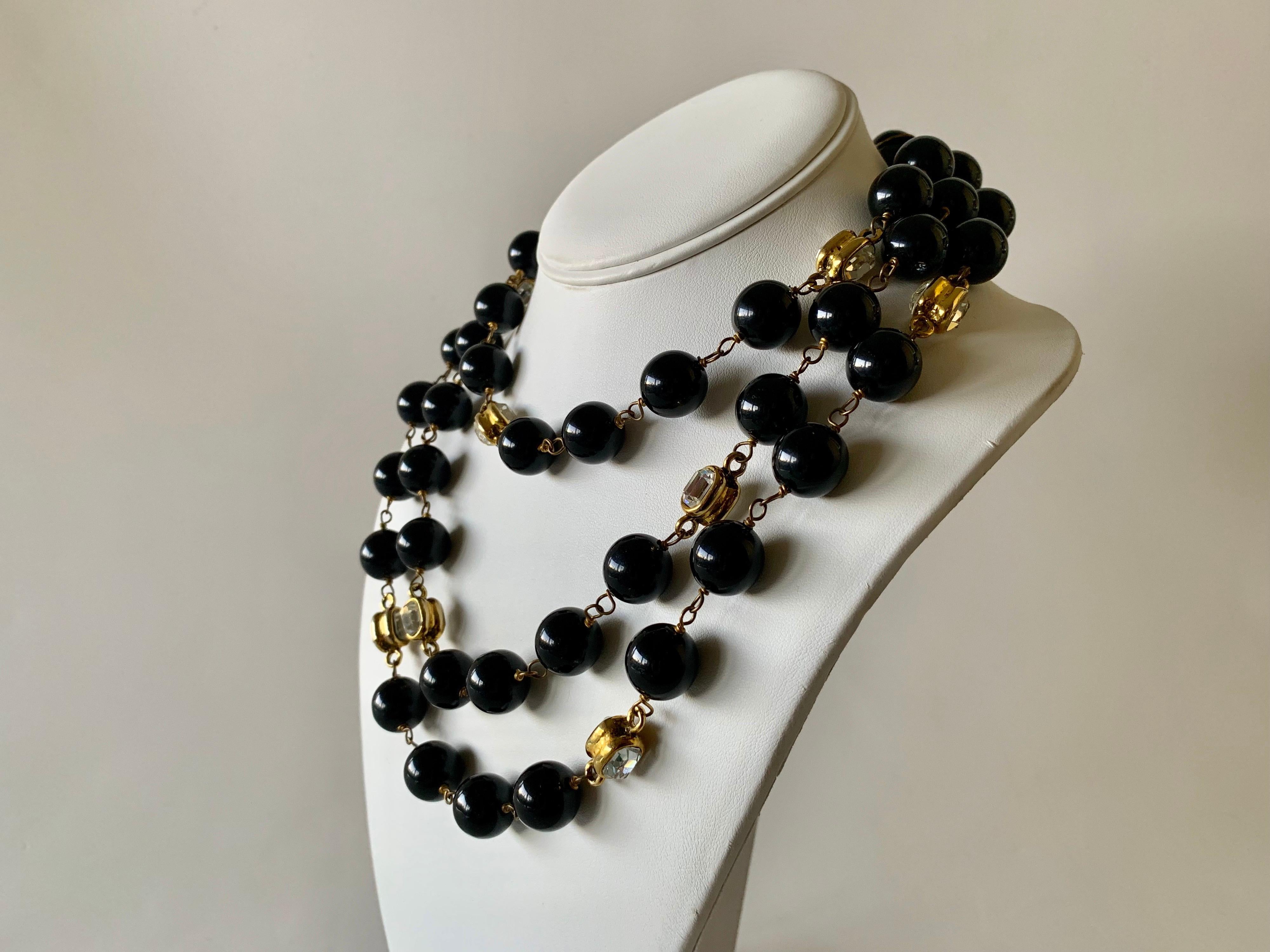Scarce vintage Coco Chanel sautoir necklace made in France, 1984 - the long statement necklace features large black beads which in all Coco Chanel manner are accented by large diamante stones set in gilded metal. What make's this particular necklace