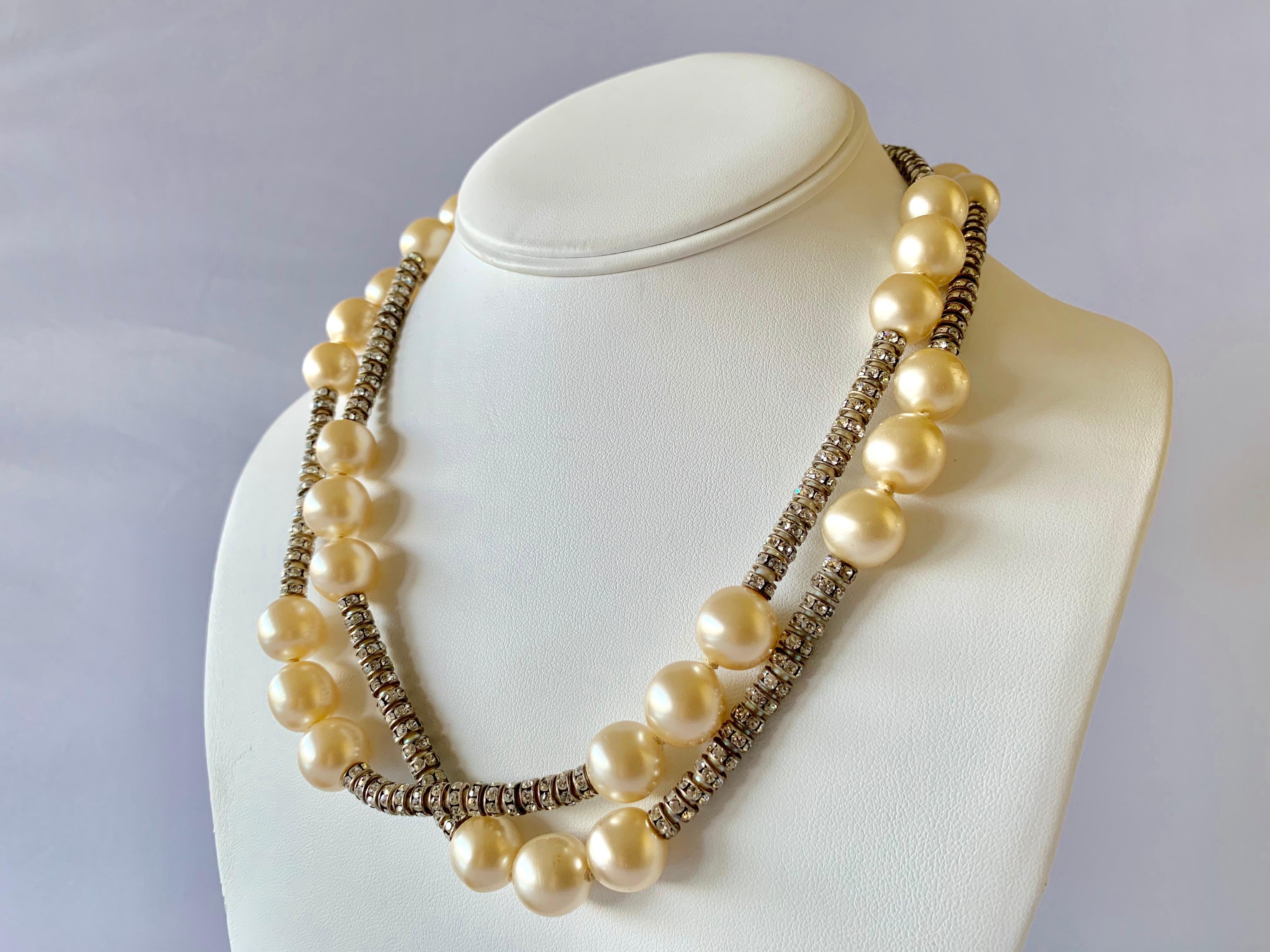 Vintage Coco Chanel silver-tone diamante and pearl statement necklace. The necklace is comprised of silver-tone metal rondels covered by clear rhinestones in a long single strand - in all Coco Chanel fashion, the necklace is accented by her