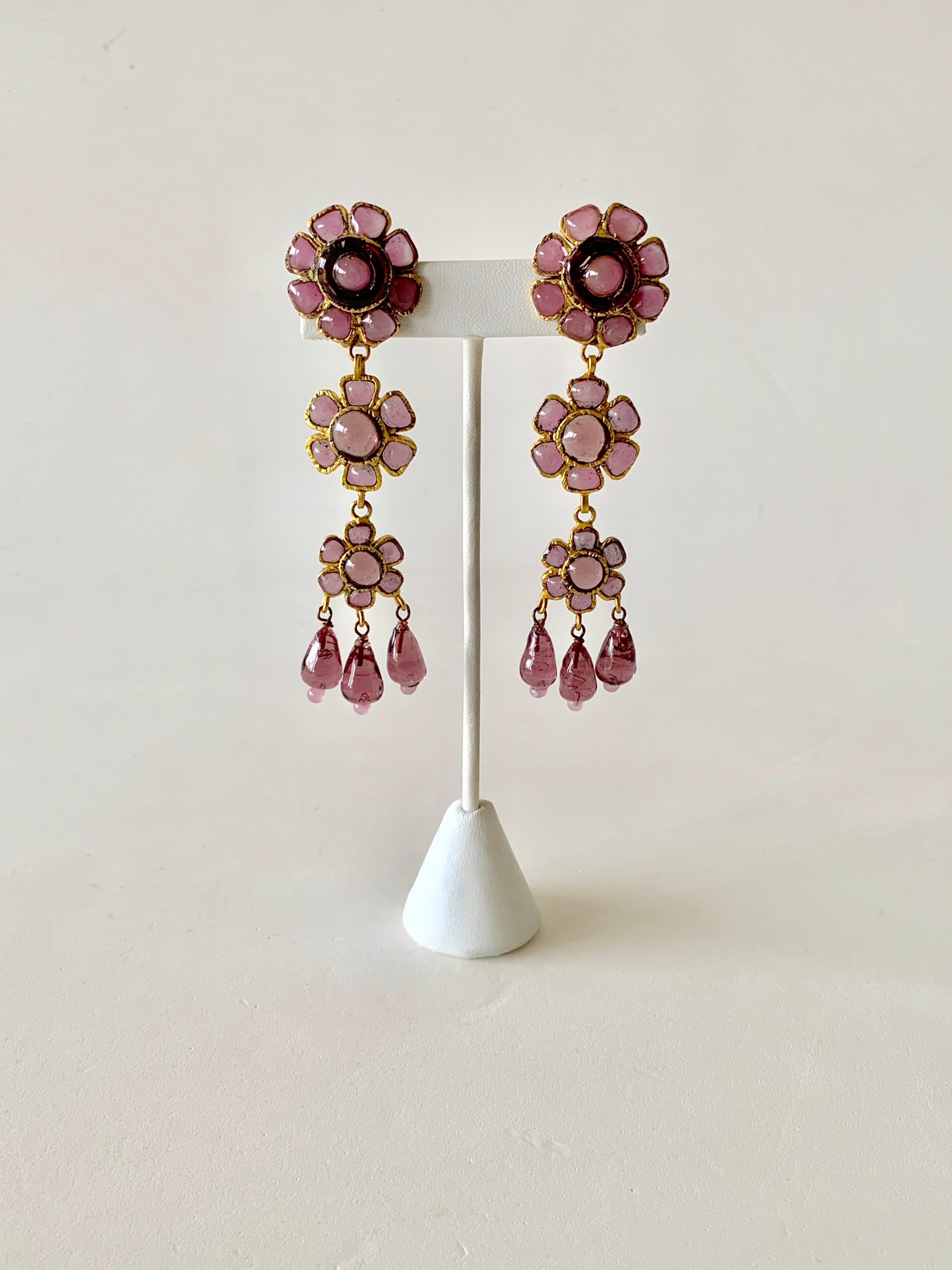 Vintage Coco Chanel clip-on statement earrings circa 1980. The chic and large lavender colored earrings feature three flower- like segments comprised out of gilt metal and feature beautiful 