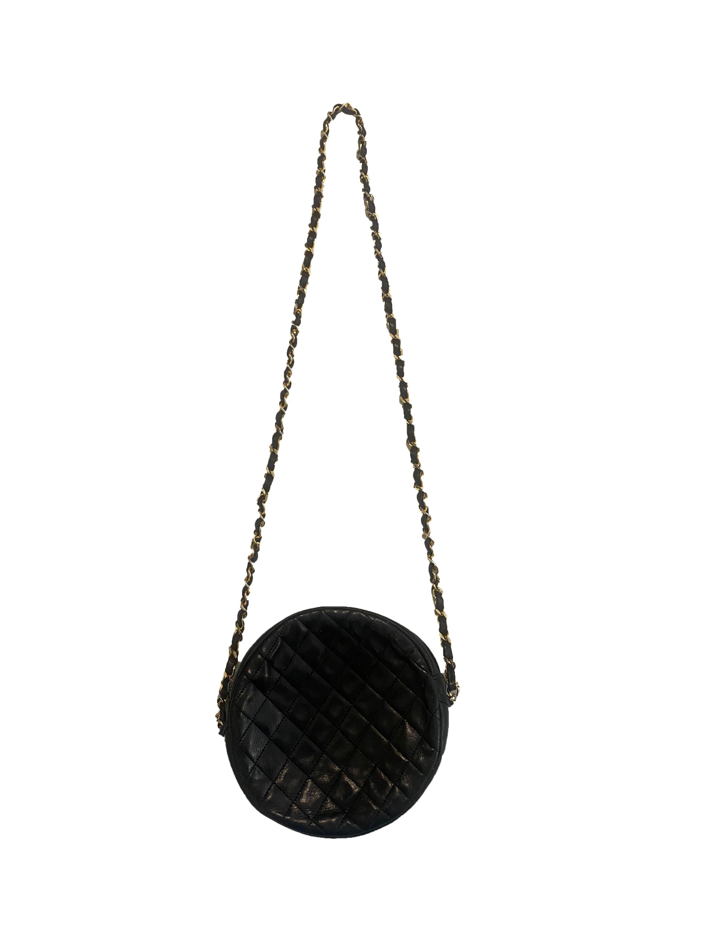 This special edition vintage Coco Line round cross body bag from Chanel is crafted in navy lambskin leather. Complete with a gold plated chain shoulder strap interlaced with navy leather. The front is embossed and stitched with the signature Chanel