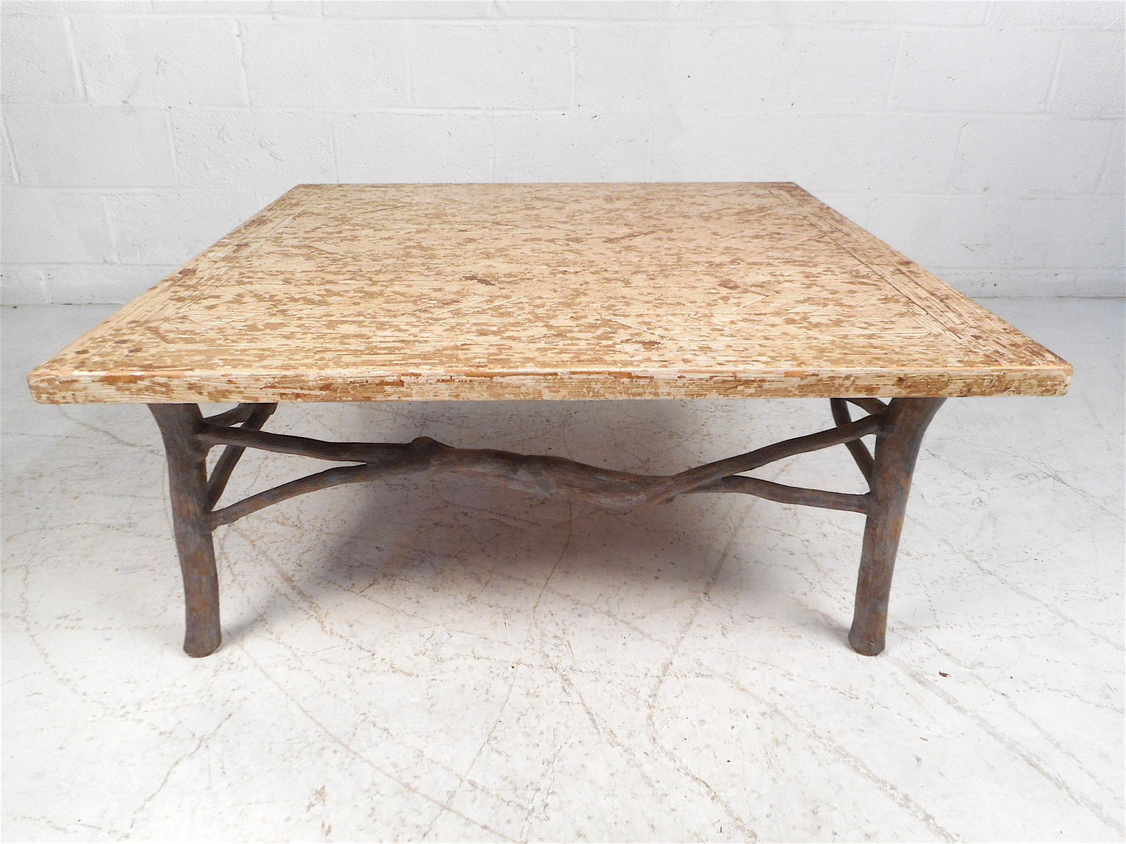 Vintage coffee table with a large, square tabletop, and an interesting metal base. The tabletop has an unusual textured finish applied. This table is sure to make a great addition to any modern interior. Please confirm item location with dealer (NJ