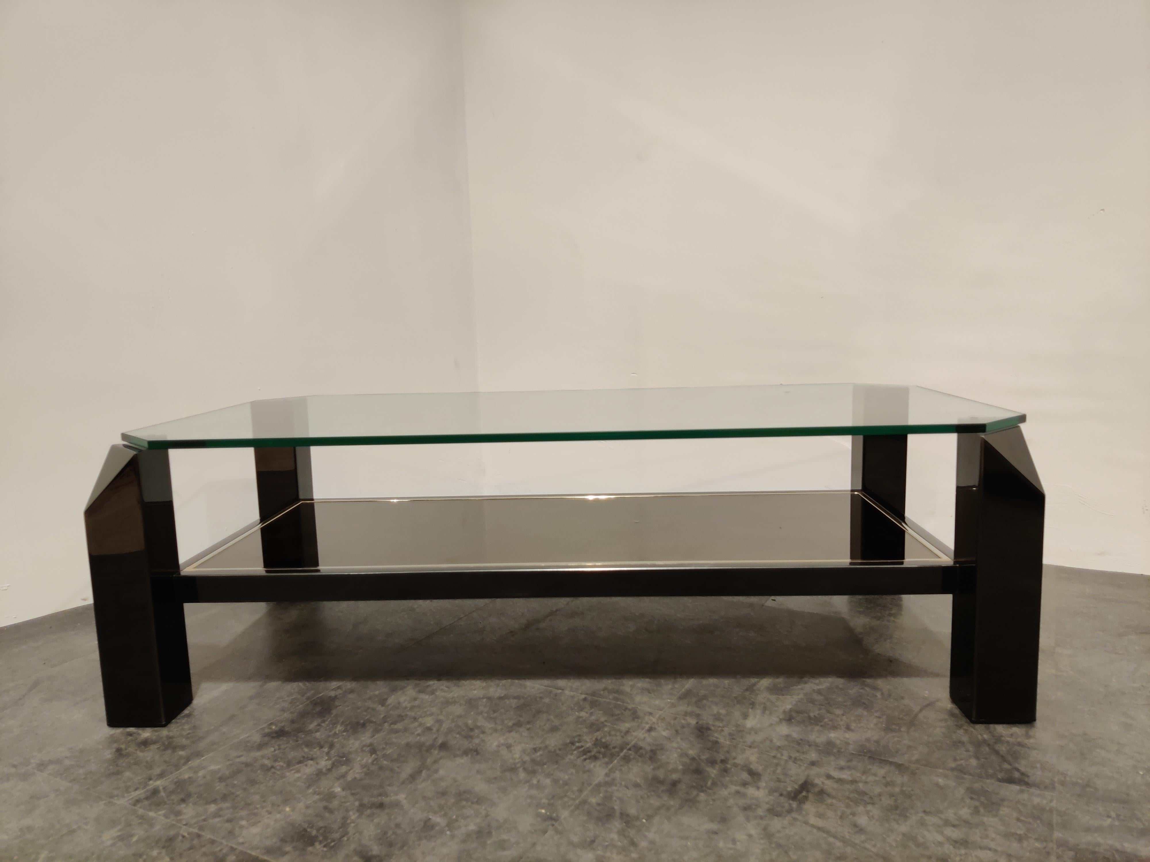 Quality 24-karat gold layered, black lacquered metal and thick clear glass coffee table manufactured by Belgochrom.

It also features a mirrored glass.

Rare black model, most of these tables are gold.

Belgochrom produced quality furniture