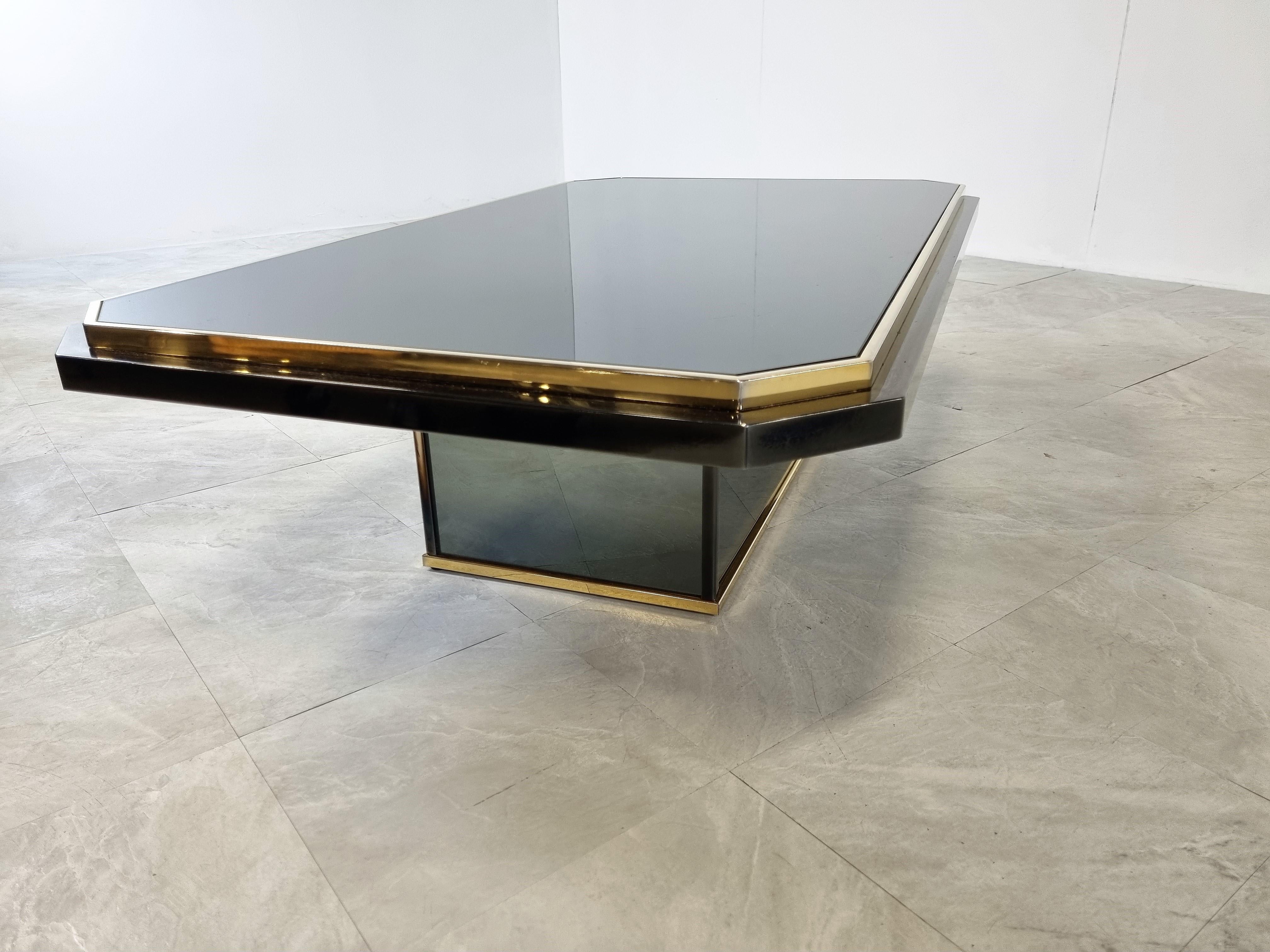 Quality 24kt gold layered, black lacquered metal and mirrored glass coffee table manufactured by Belgochrom.

It also features a mirrored glass base.

Belgochrom produced quality furniture pieces with a luxurious appeal.

Very good