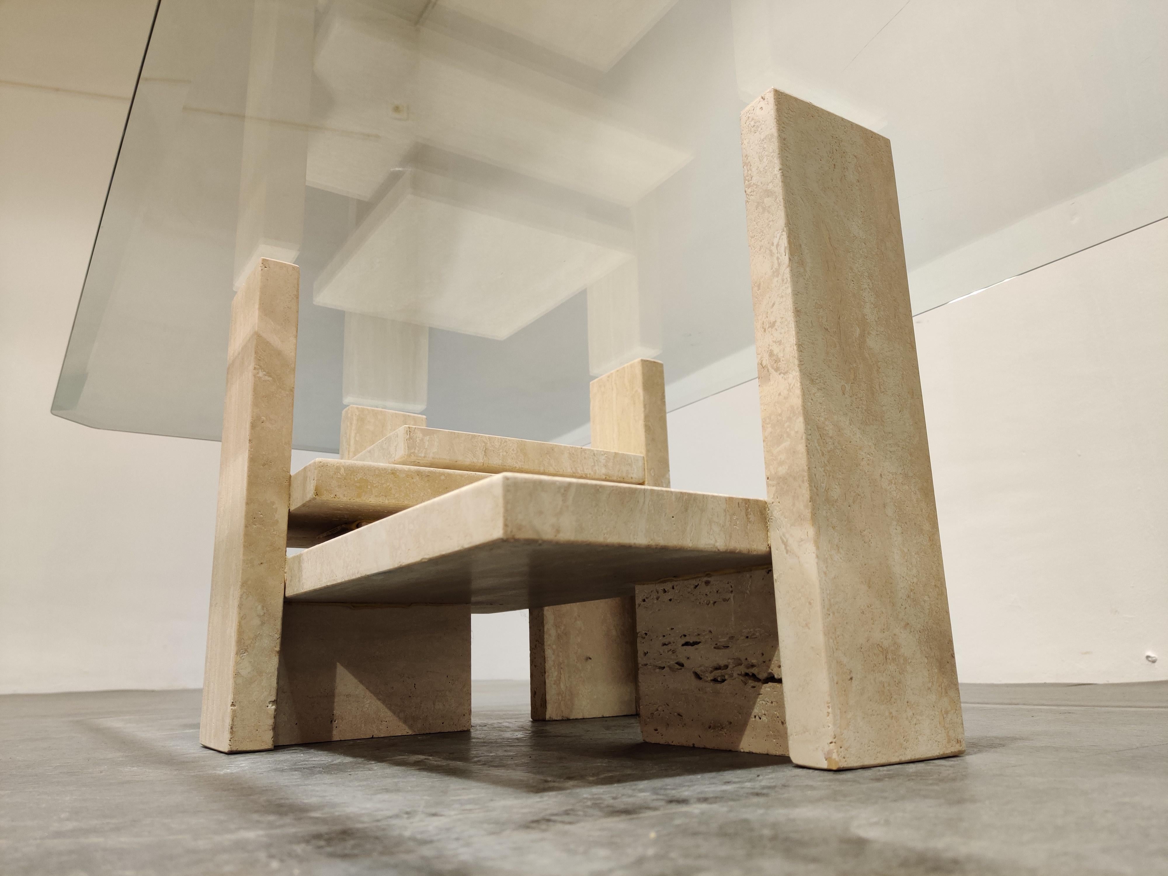 Architectural coffee table made from a solid travertine base and with a beveled glass top.

The table was designed by Willy Ballez.

All these tables are handmade, so they are always a bit different.

The modern look/design mixes well with