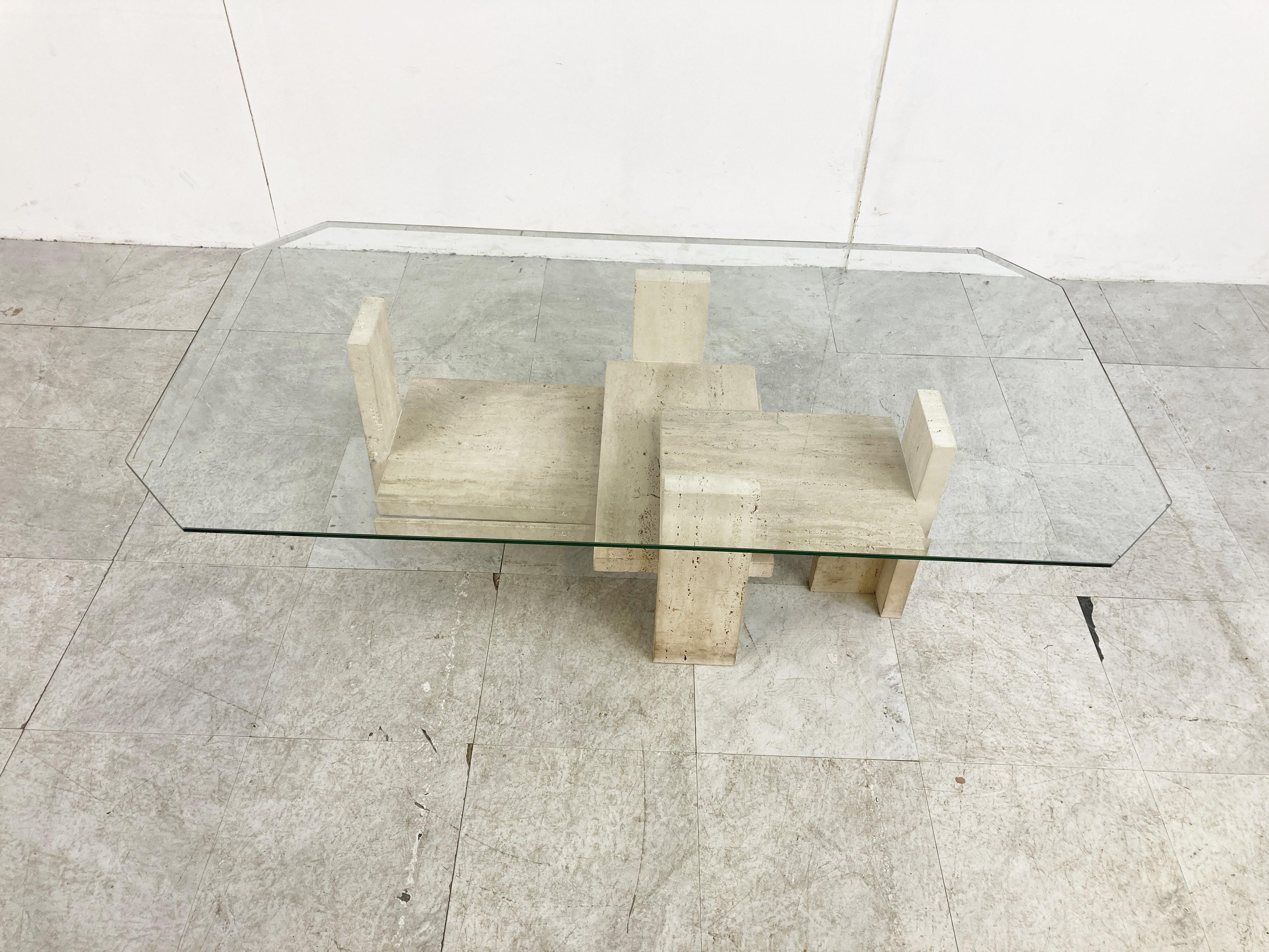 Architectural coffee table made from a solid travertine base. 

The table was designed by Willy Ballez.

All these tables are handmade, so they are always a bit different.

The modern look/design mixes well with nowadays interiors, especially