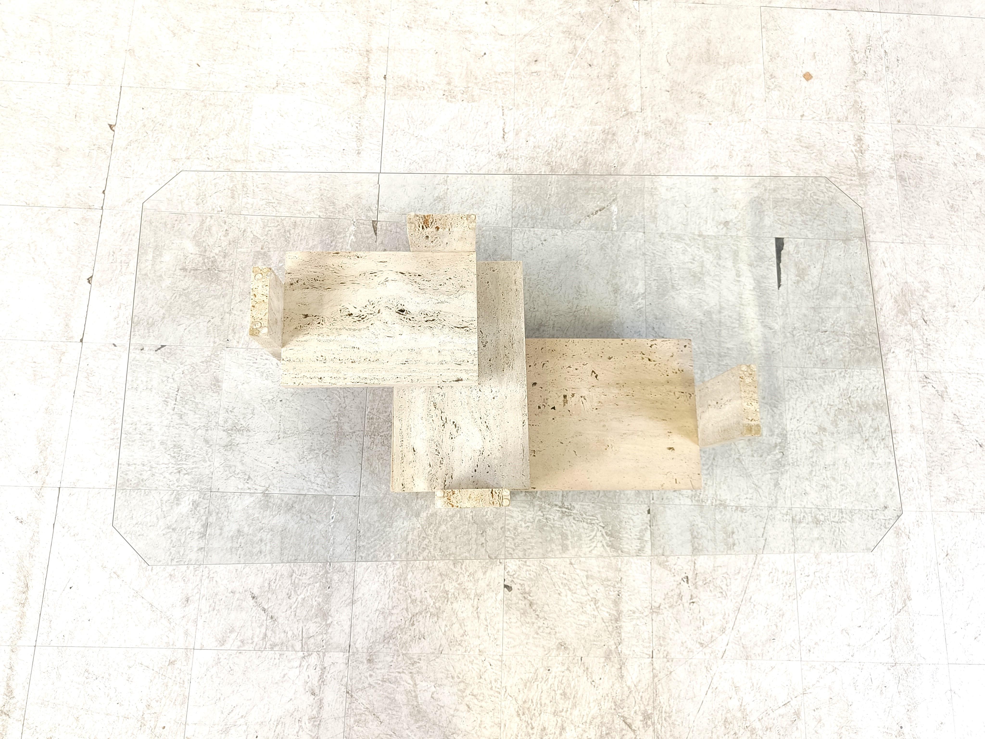 Architectural coffee table made from a solid travertine base. 

The table was designed by Willy Ballez.

All these tables are hand made, so they are always a bit different.

The modern look/design mixes well with nowadays interiors, especially with