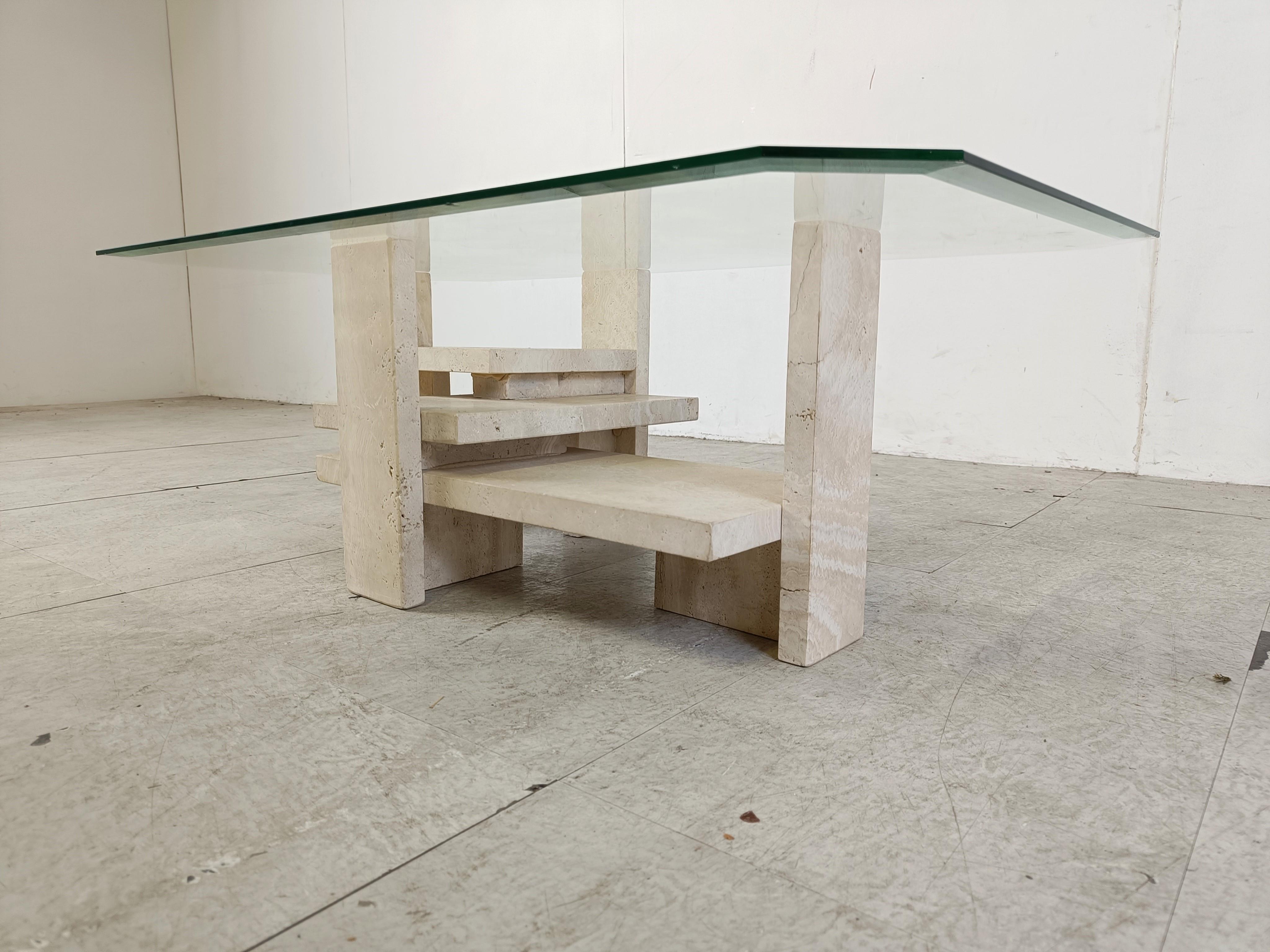 Architectural coffee table made from a solid travertine base. 

The table was designed by Willy Ballez.

All these tables are hand made, so they are always a bit different.

The modern look/design mixes well with nowadays interiors, especially with