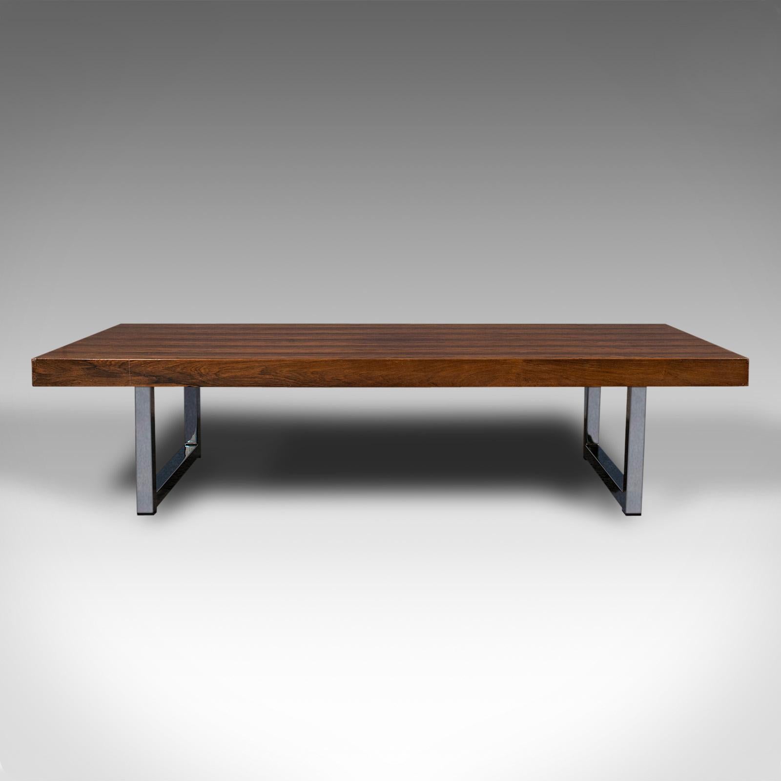 This is a quality vintage coffee table. An English, rosewood table with Danish influence, after Merrow Associates, dating to the mid 20th century, circa 1960.

Strikingly attractive example of sought-after, mid century furniture
Displays a