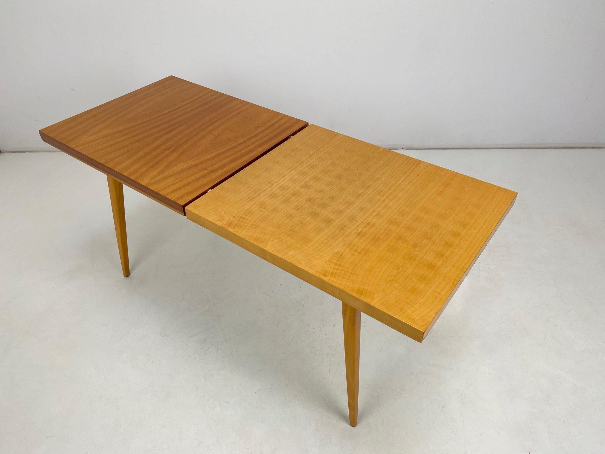 Vintage two-tone coffee table from former Czechoslovakia. The top is in glossy finish.