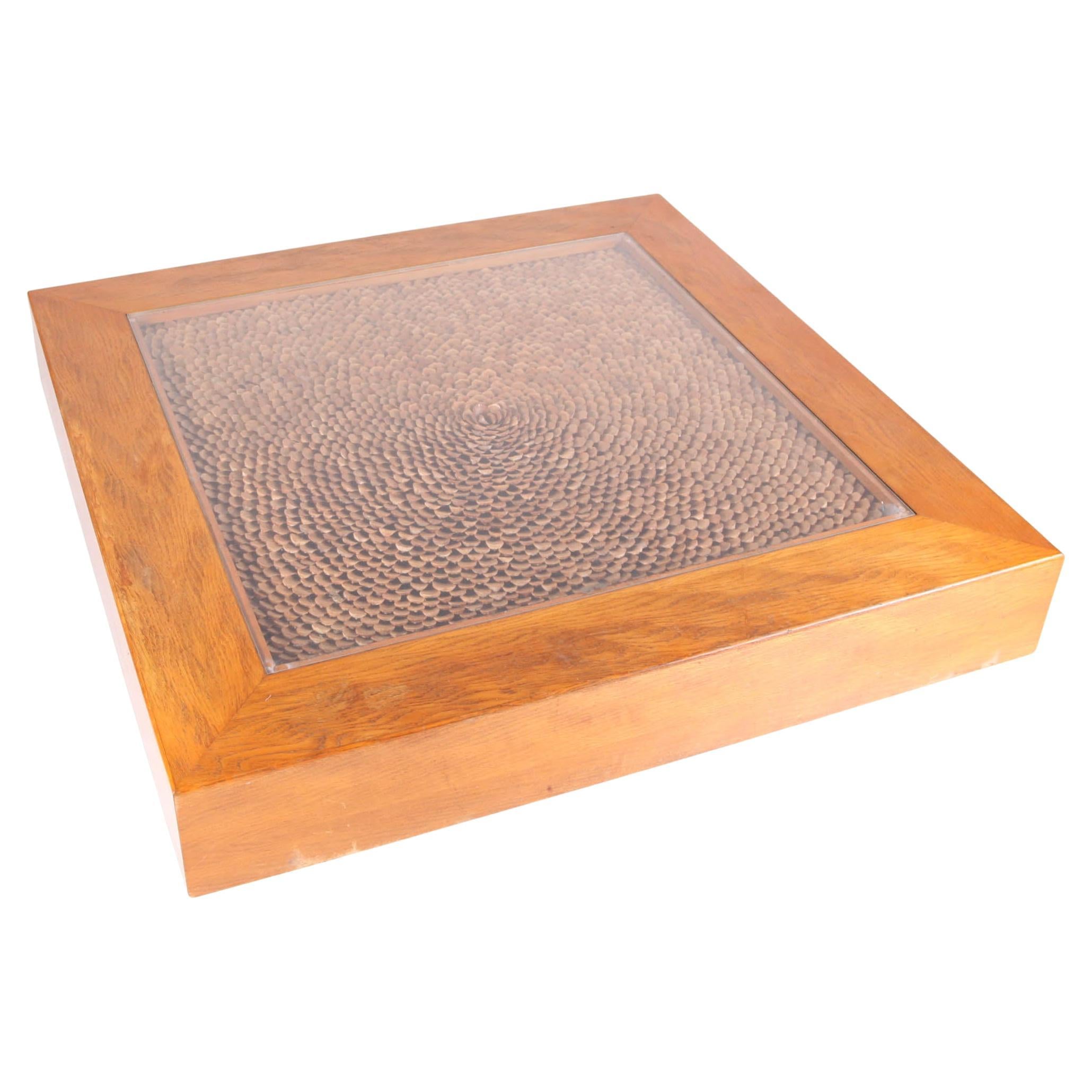 Vintage coffee table in wood and scales of pine cones with glass top