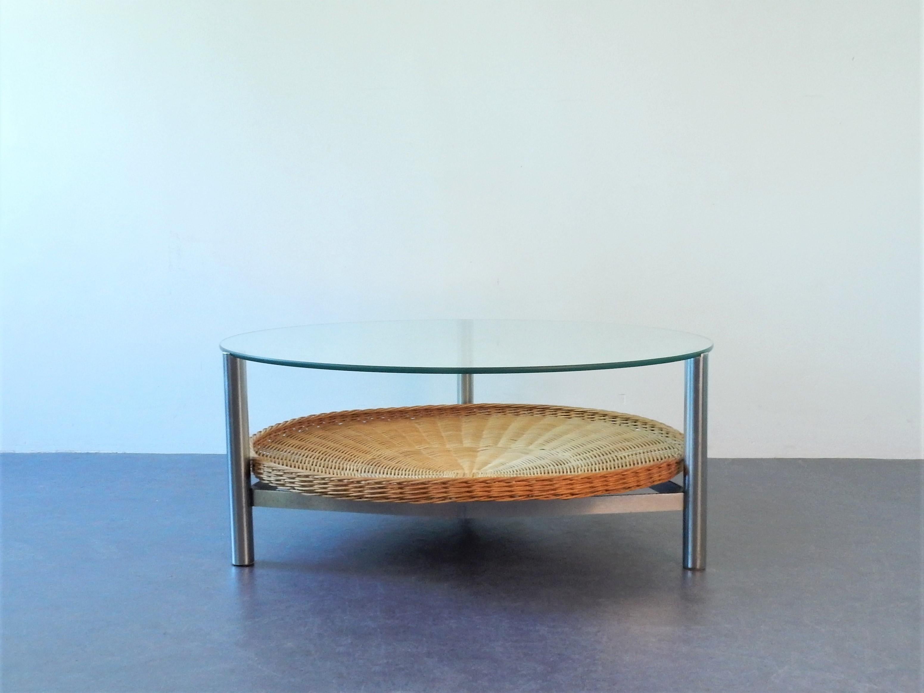 The design of this table does show similarities to the designs and productions of Rohé. It has some scratches and chiploss to the glass top from use and the metal frame shows signs of use as well. The frame and three legs are of solid and heavy