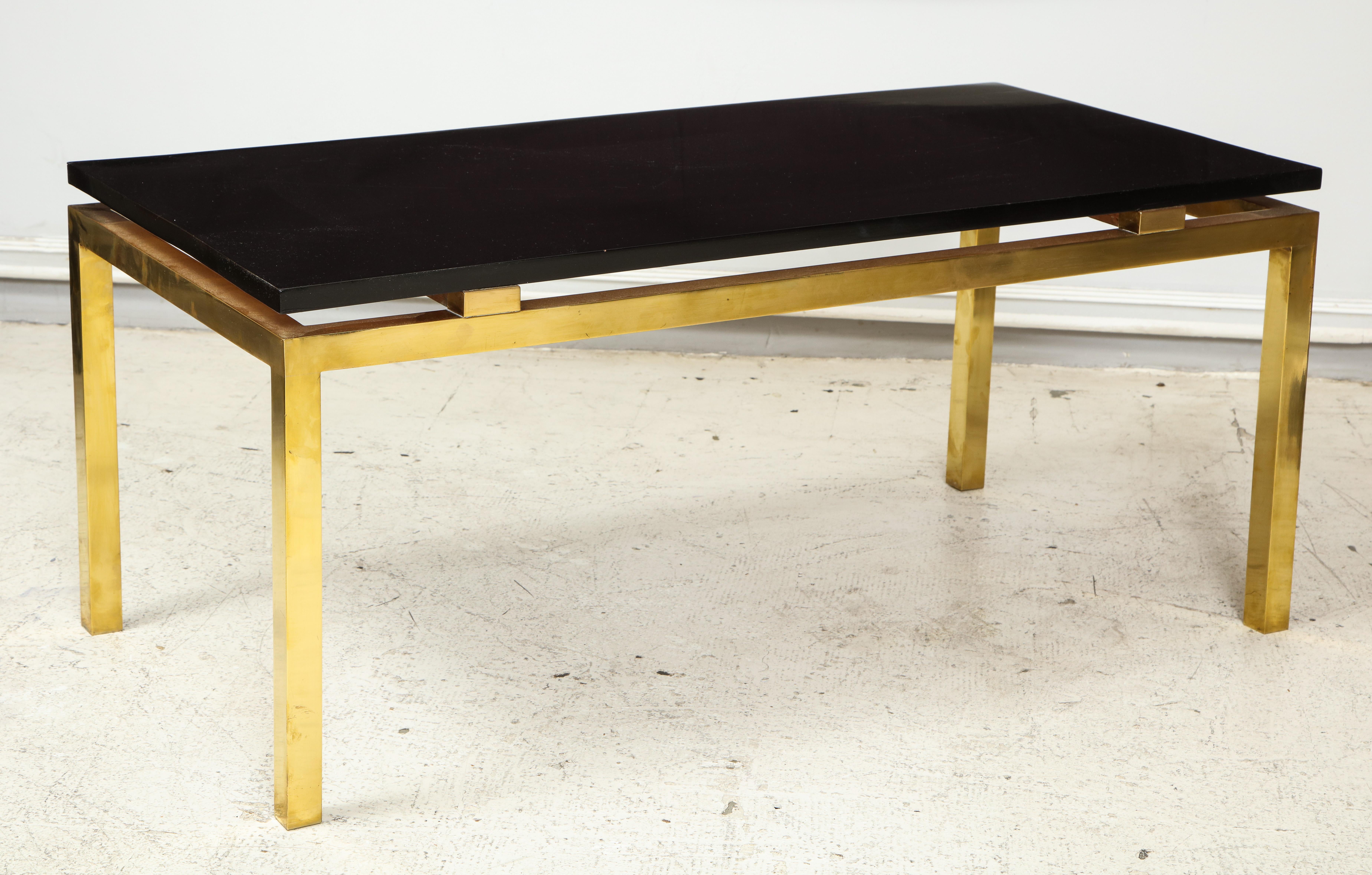 Vintage coffee table with lacquered top on brass base.