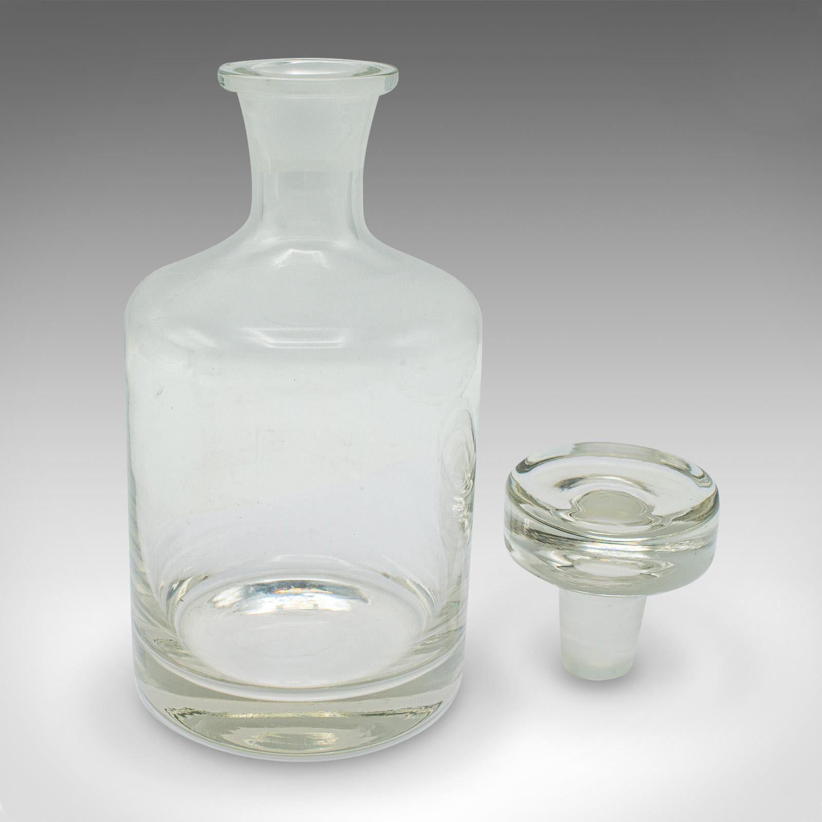 
This is a vintage cognac decanter. An English, glass spirit vessel, dating to the mid 20th century, circa 1950.

Pleasingly tactile decanter with a bold stopper
Displays a desirable aged patina, in good original order
Quality glass presents a