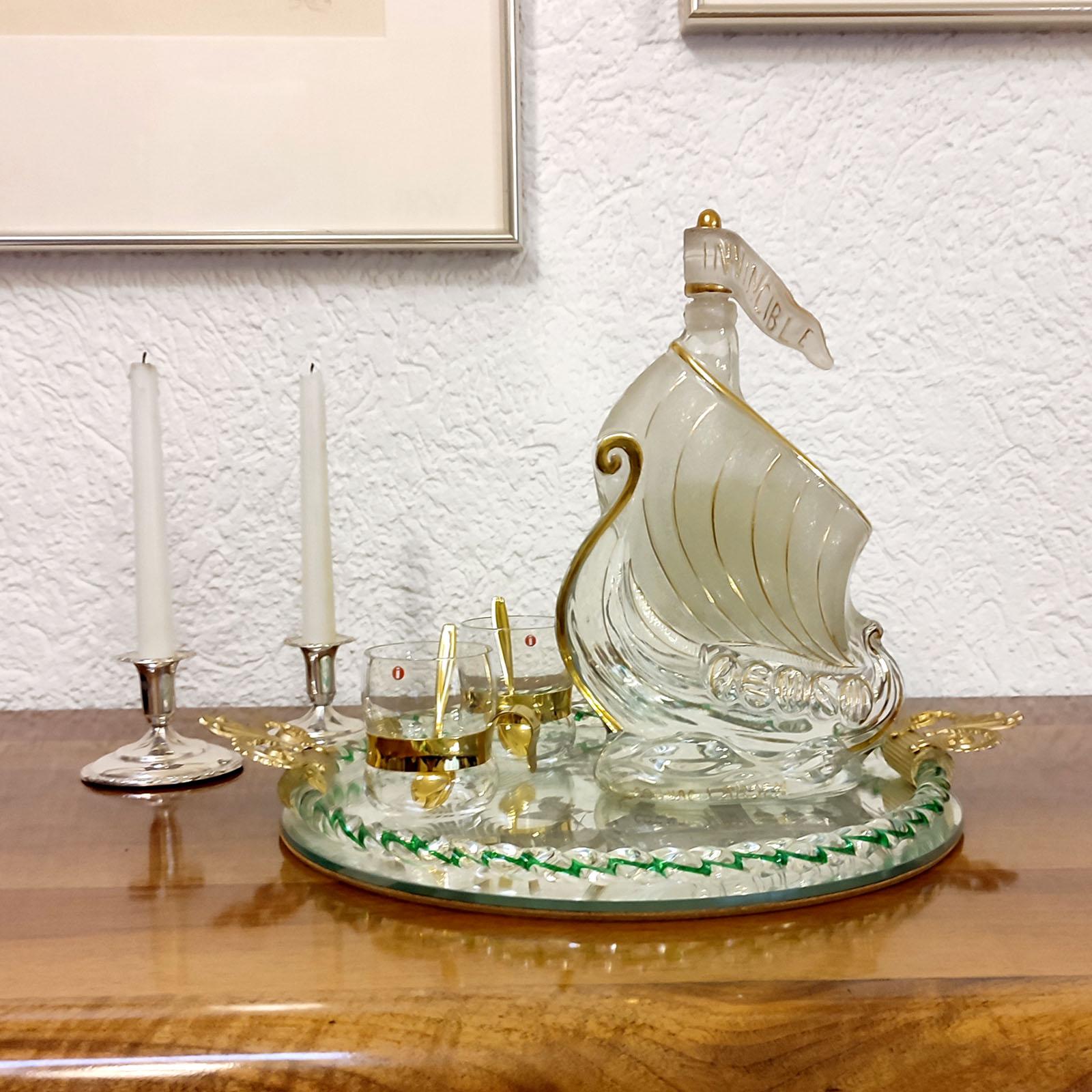 Very attractive cognac decanter with stopper, shaped as a Viking ship. Made of clear glass, frosted glass and gold trim highlighting the shape of the ship. Excellent used condition.
Dimensions: 20 x 7.5 x 31 cm (8x3x12 in.).