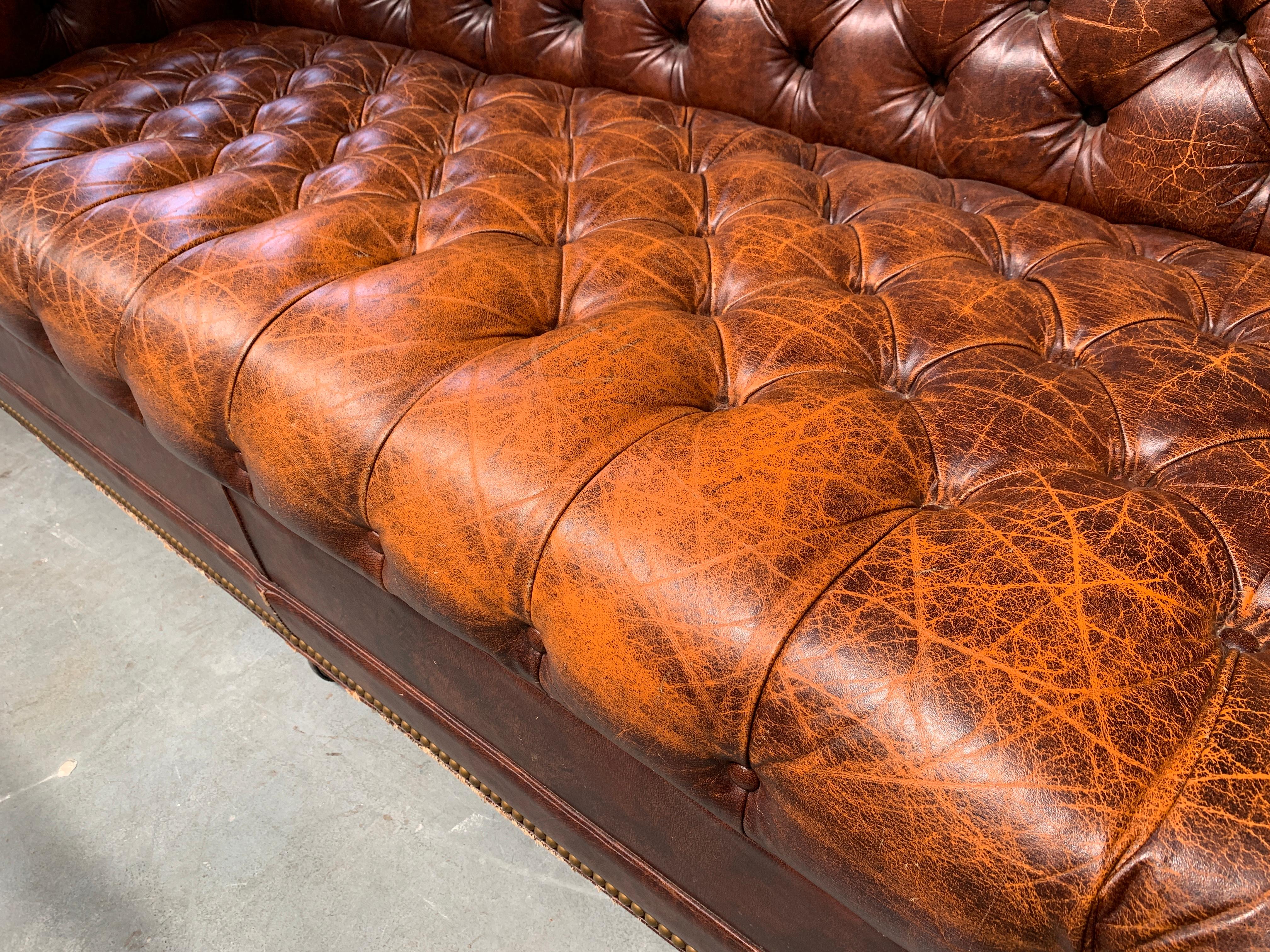The Chesterfield is a classic design staple, with tufted leather upholstery and rolled arms - this piece is timeless. The leather on this piece is softly aged but in great condition, the front legs are casters so it is easy to move.