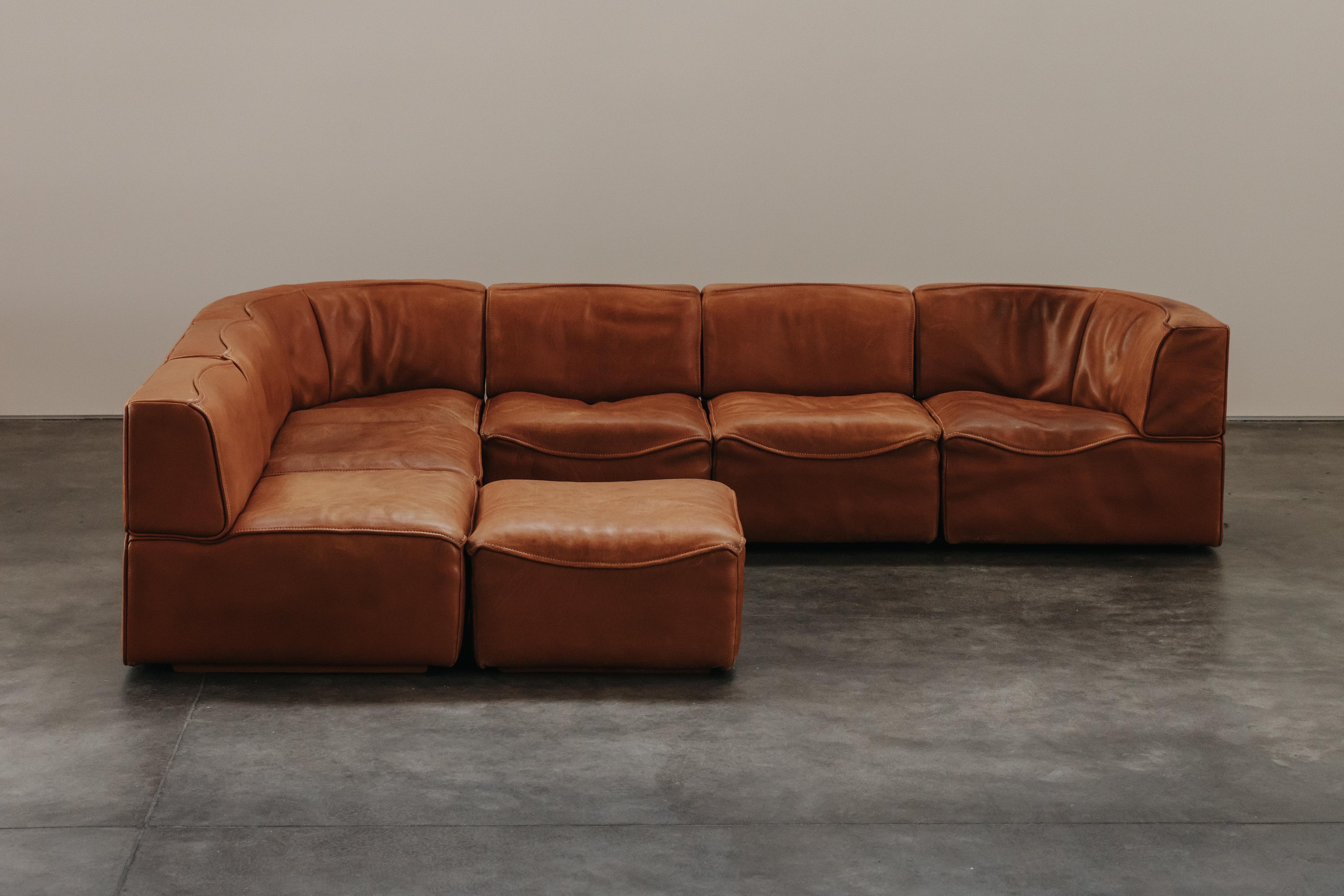 Vintage Cognac Leather De Sede DS-15 Sofa From Switzerland, Circa 1970.  Six modular pieces and an ottoman in thick cognac buffalo leather.  Superb quality and design.