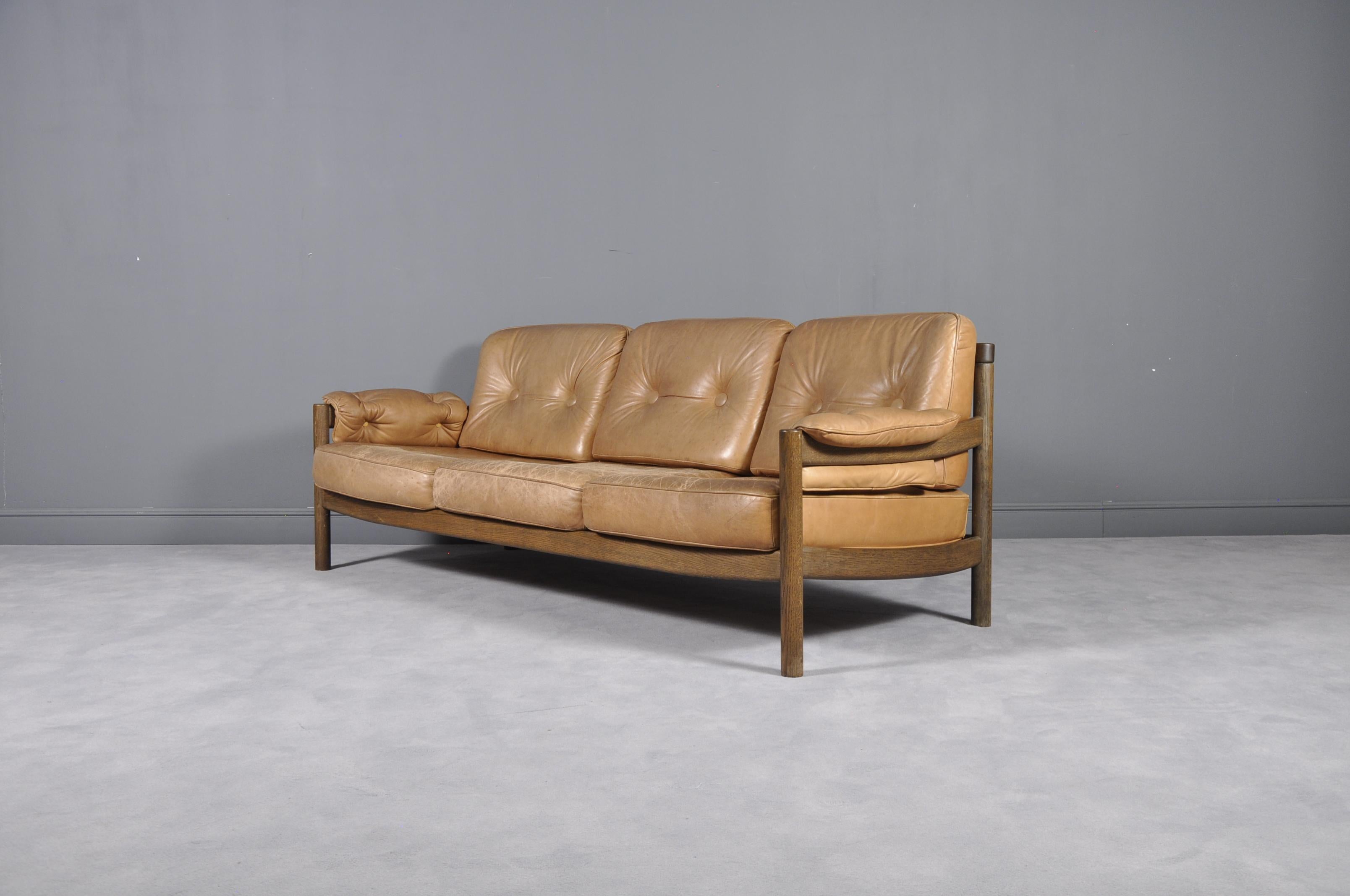 - Comfortable 3-seat sofa from the 1960s
- Original cognac color leather with patina 
- Solid wooden frame.