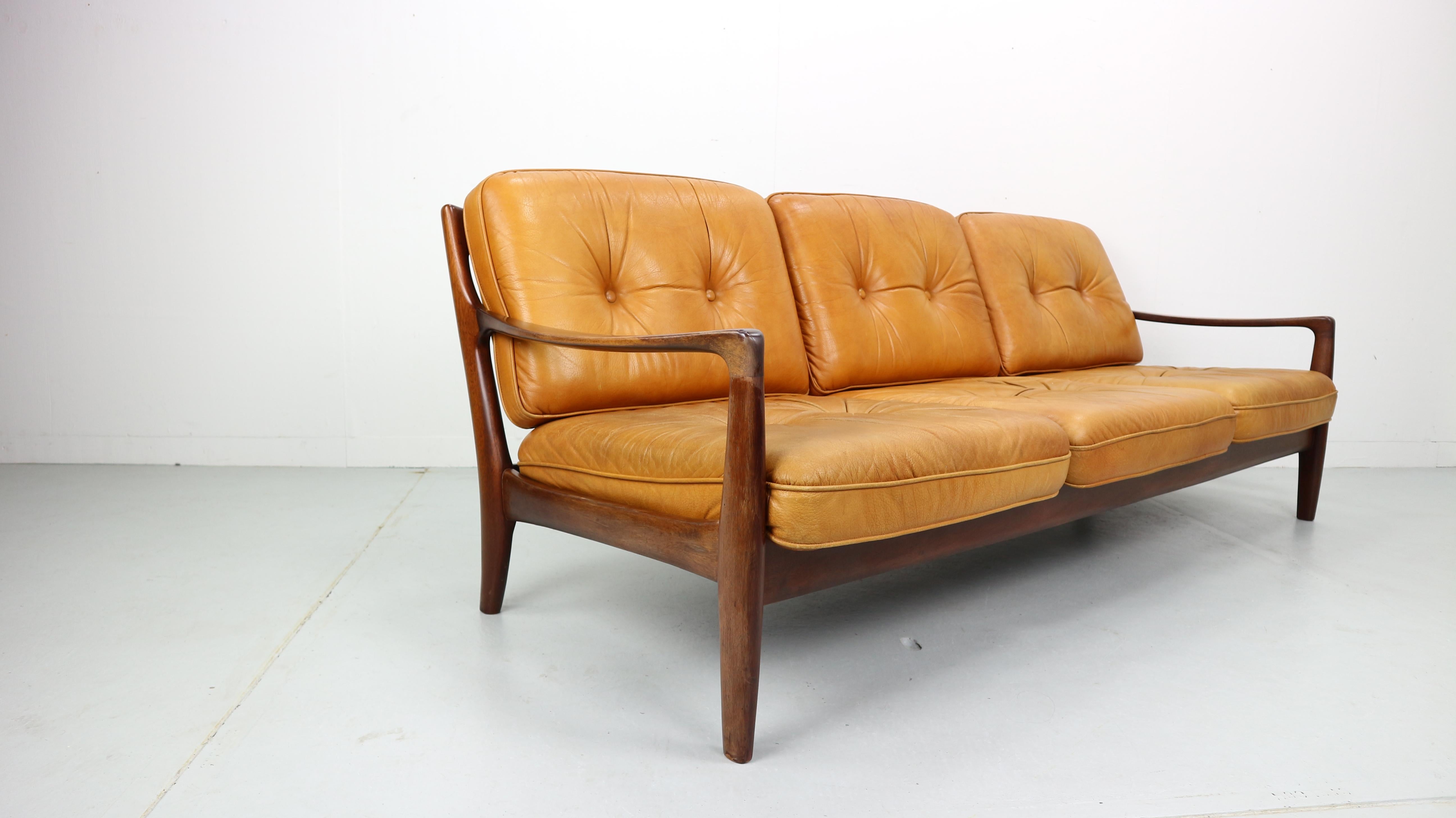 This 1960s vintage comfortable sofa is an eyecatcher for your home.
Original cognac color leather is in a good vintage condition.
Solid wooden frame.
Three-seat.
Made in Denmark.


 