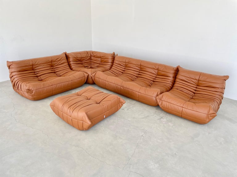 Classic French Togo set by Michel Ducaroy for luxury brand Ligne Roset. Originally designed in the 1970s the iconic togo sofa is now a design classic. This set comes in its original cognac saddle leather.

Timeless comfort and style make this