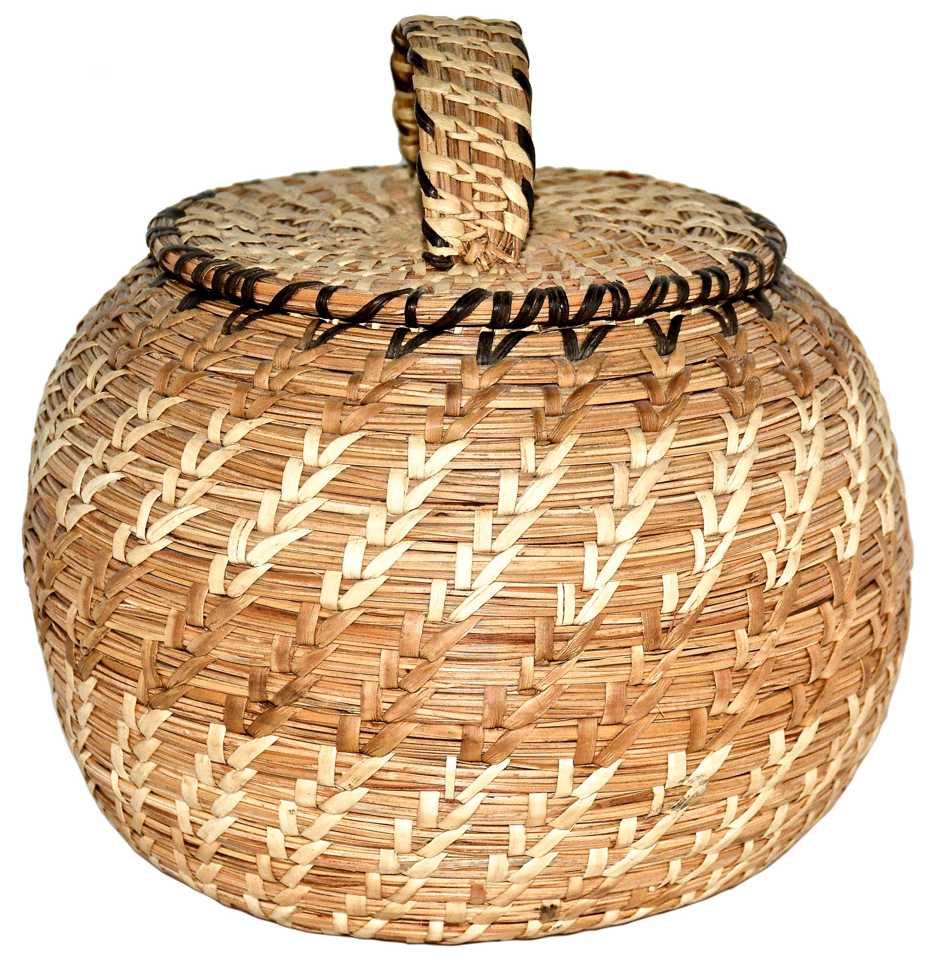 Coiled lidded grass basket
Eskimo
Tununak, Alaska
Beach grass
1960s
Measures: 7 inches Height. x 4 inches in Diameter

This is a vintage Eskimo basket from Tununak, Alaska and was made in the 1960s.

Far to the west along the shores of