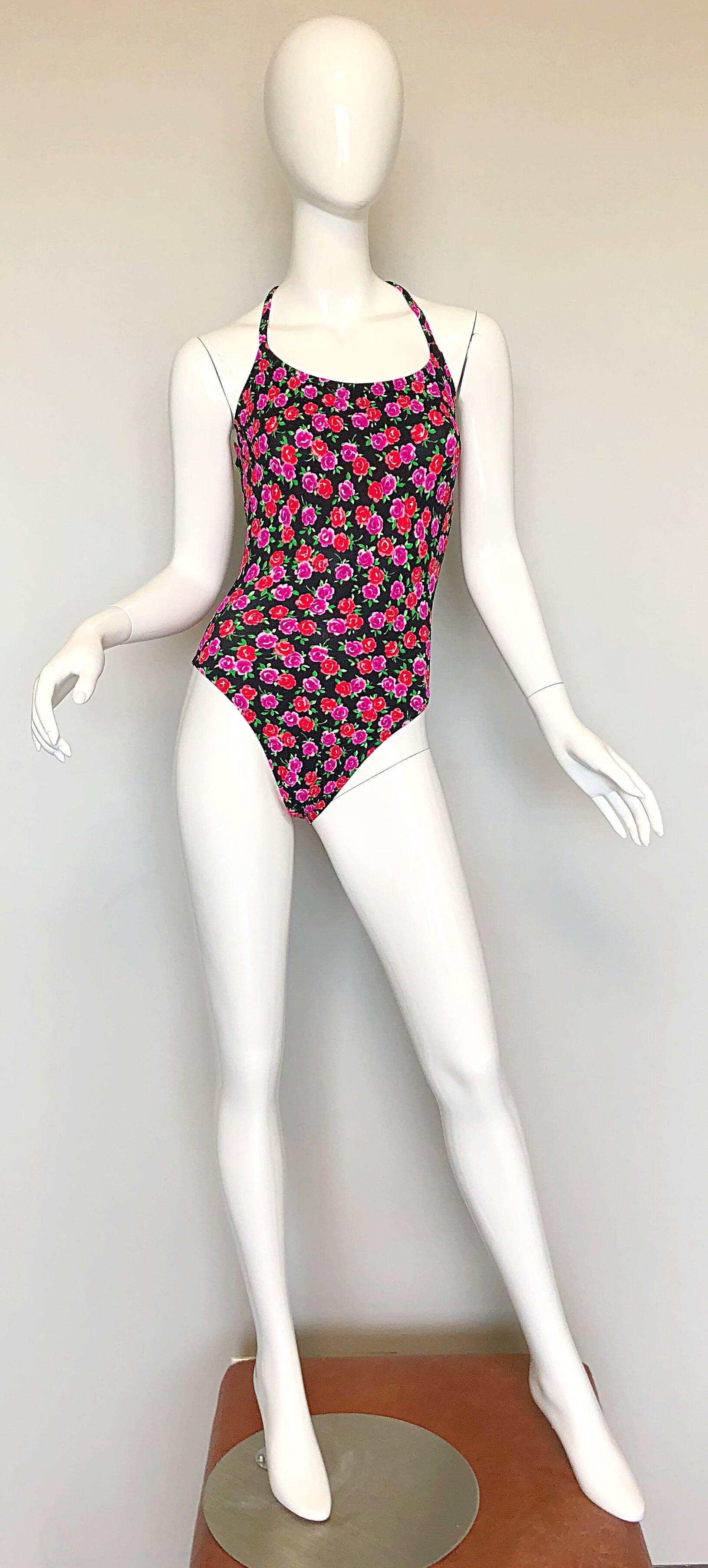 Pretty vintage early 80s COLE OF CALIFORNIA pink, red and black rose print racerback one piece swimsuit or bodysuit! Features an allover print of roses in hot pink, red, green and black. Flattering soft material stretches to fit. Racerback straps