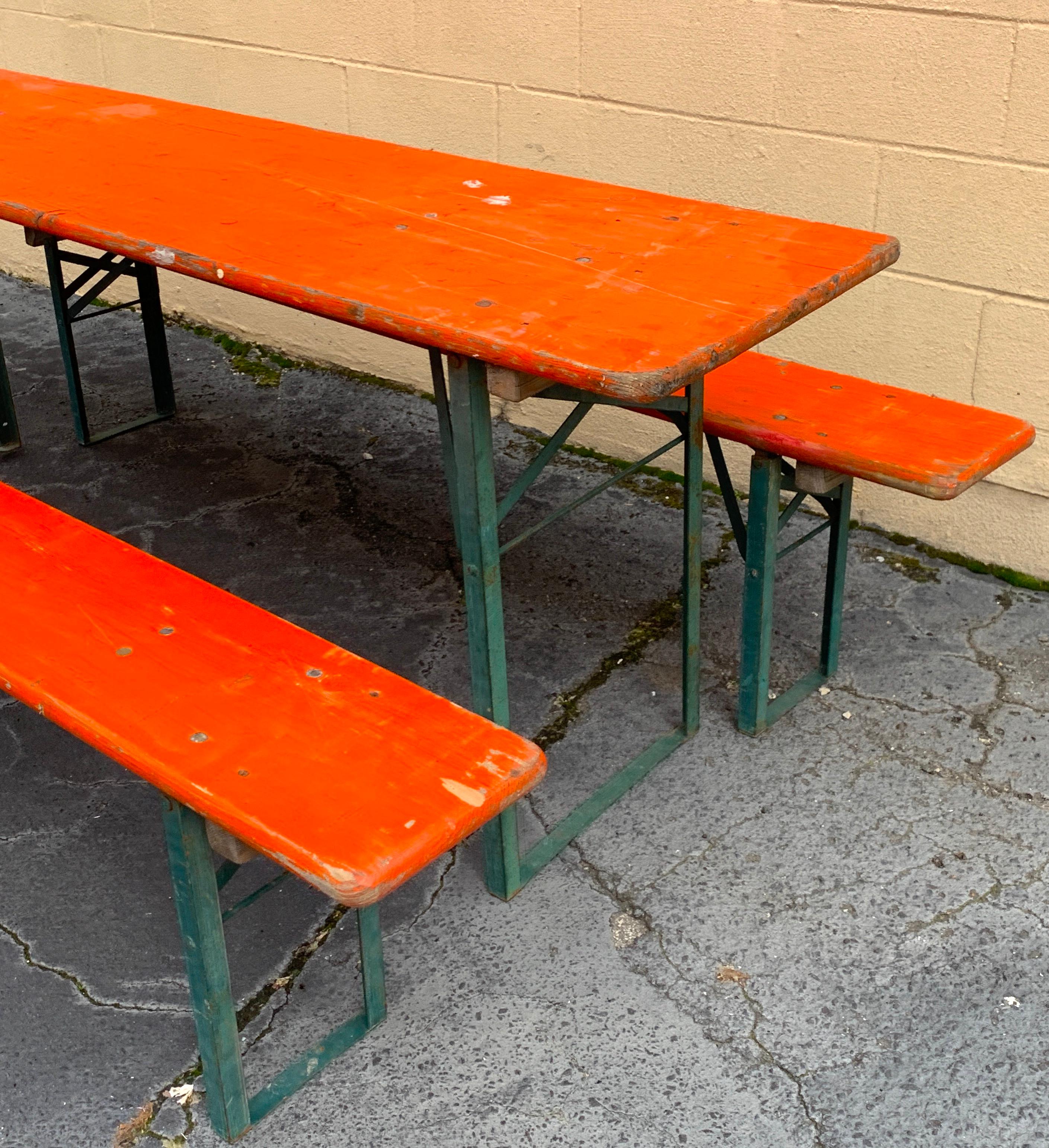 Vintage Collapsable German beer garden table and bench set, in orange
Consisting of a folding table and two folding benches in vintage orange paint.
Great size and color, very sturdy, show signs of use and patina. Structurally sound, mechanics
