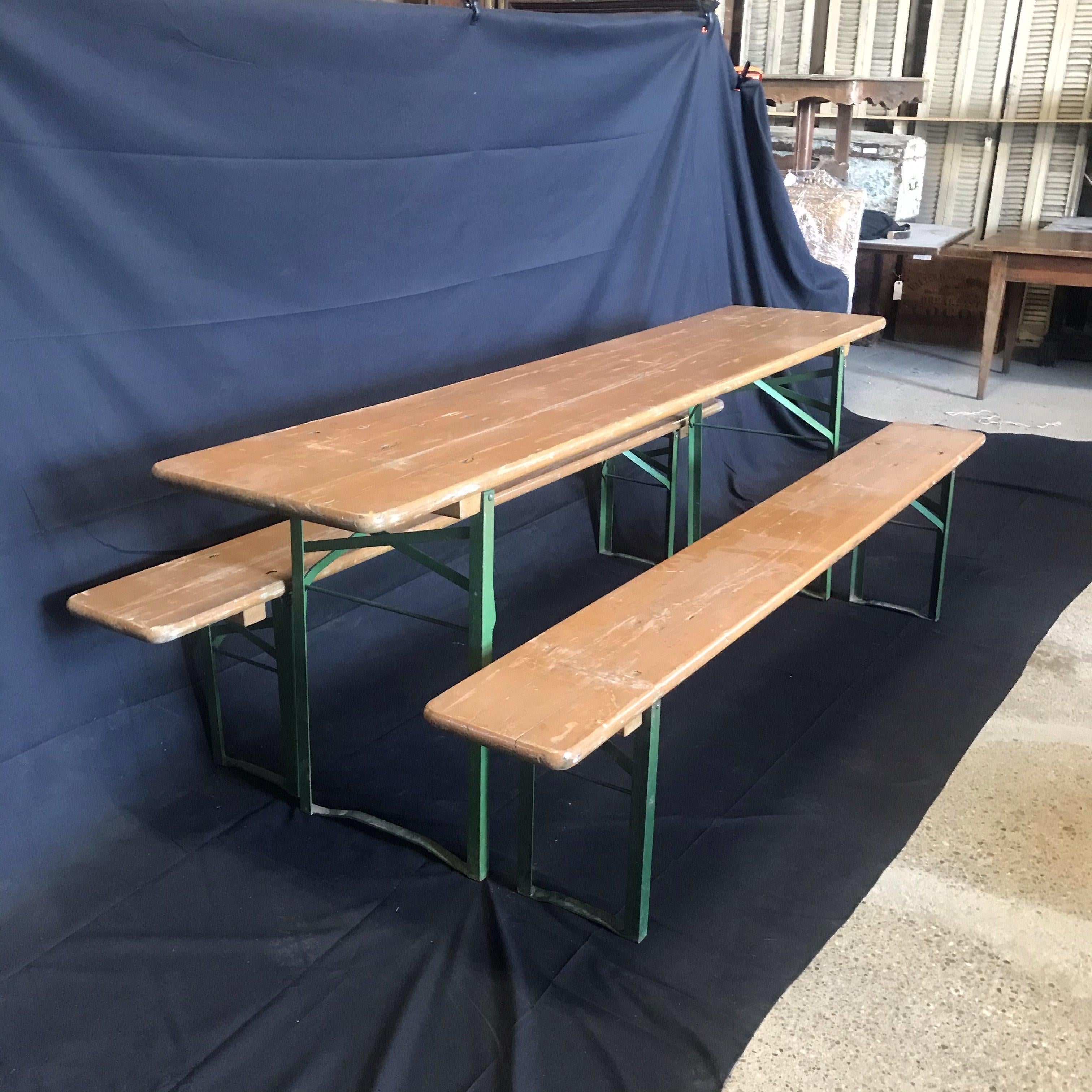 Vintage collapsible German beer garden table and bench set, consisting of a folding table and two folding benches in vintage paint. Great size and color, very sturdy, shows sign of use and wear with character rich patina. Structurally sound,