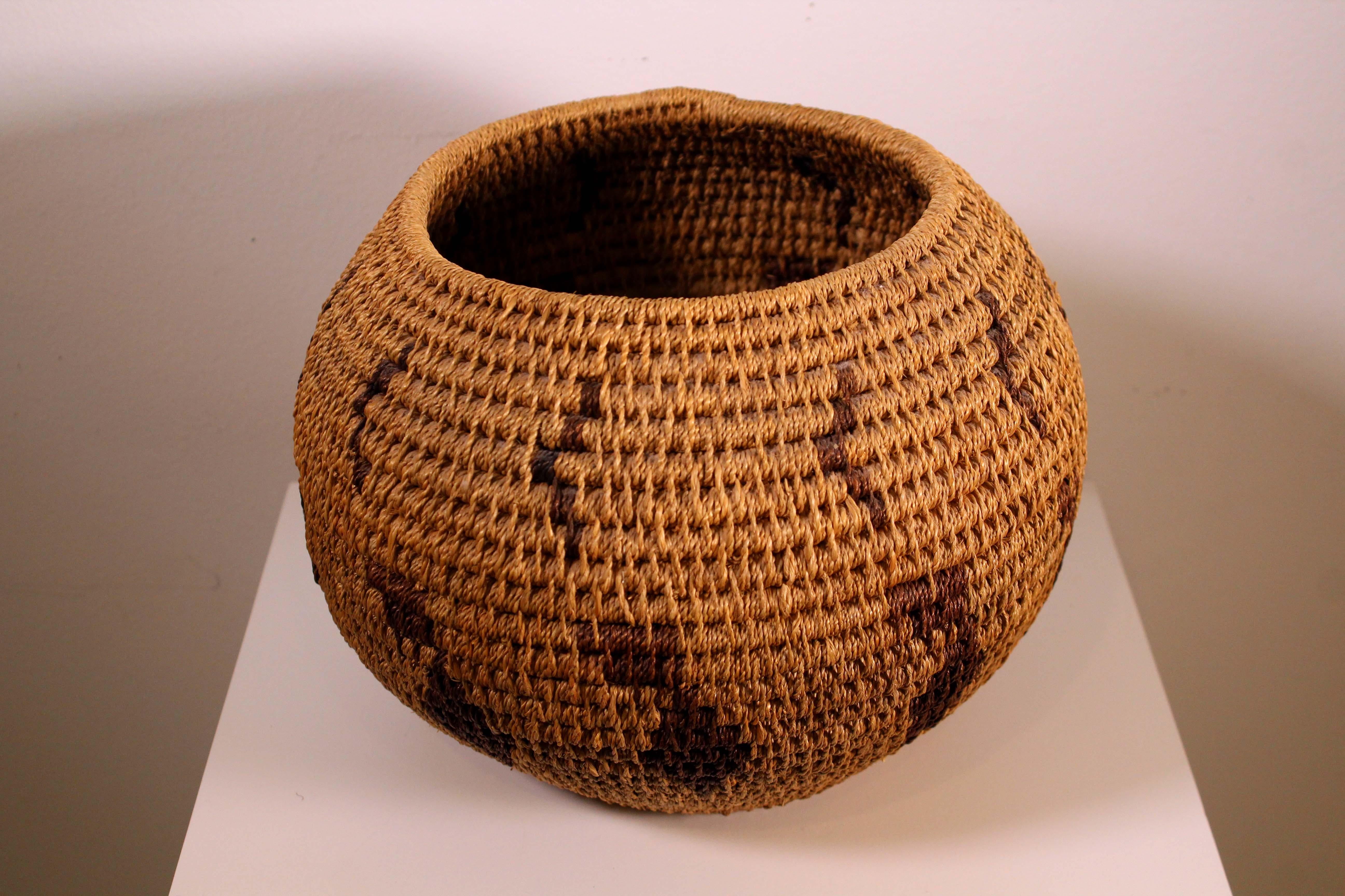 An intricate Hopi Pueblo woven ceremonial basket. Hopi basket weaving has been a part of Native American tradition for hundreds of years ago and the original purpose was solely utilitarian. Then the baskets were created for ceremonial life and in
