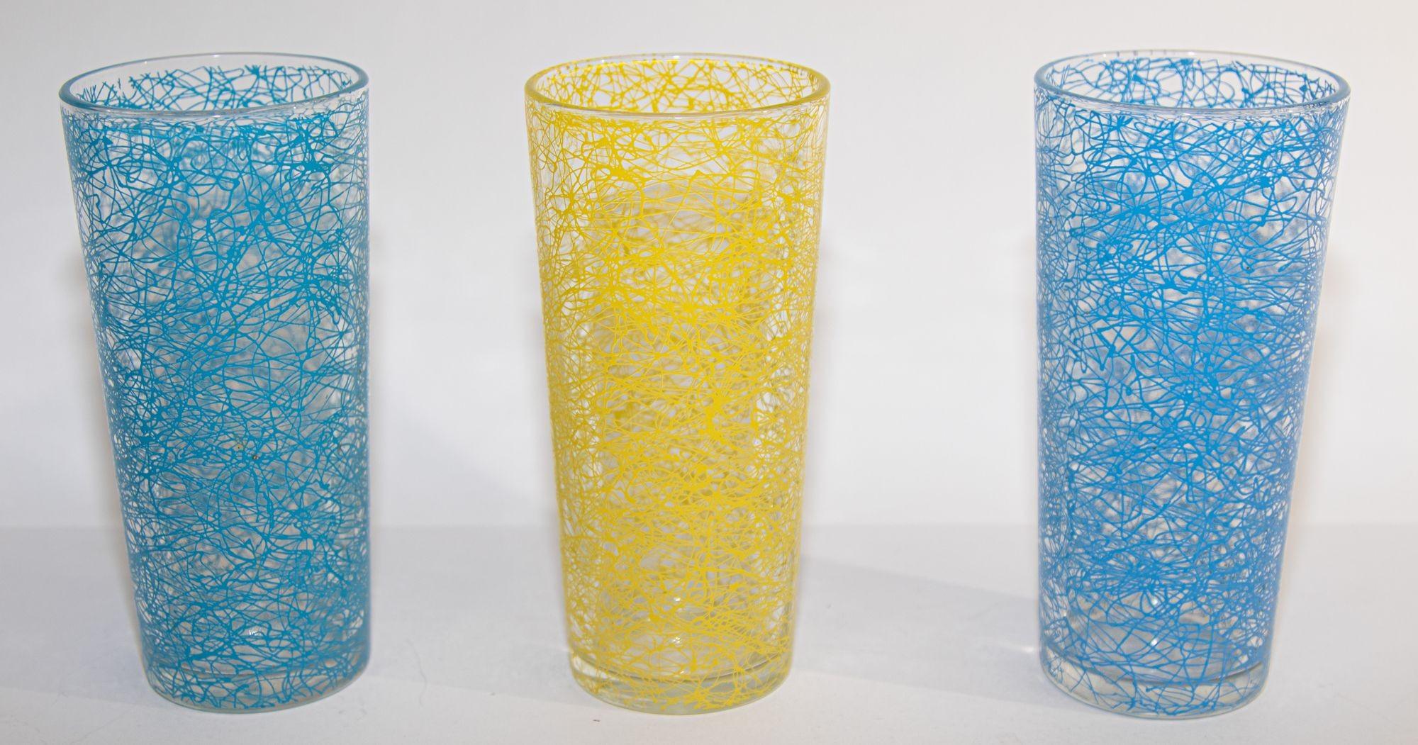Set of three vintage collectible retro spaghetti string tumblers.
Set includes 3 highball vintage yellow gold and powder blue spaghetti drizzle drinking glasses.
Fantastic midcentury set of 3, barware, glassware, midcentury, circa