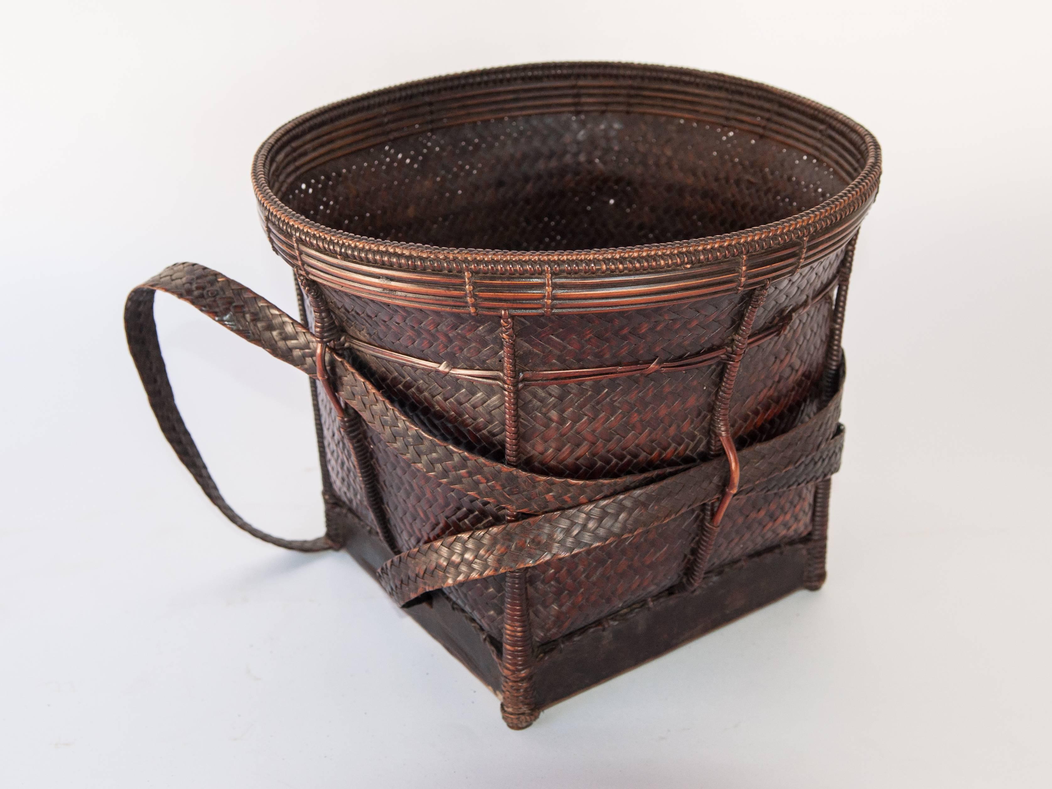 Vintage collecting basket from the Ata Pue area of Laos. Mid-20th century, Bamboo, rattan.
Offered by Bruce Hughes.
This sturdy and finely woven basket is from the Ata Pue area of Laos, and possesses a lovely rich patina. Laotians are highly