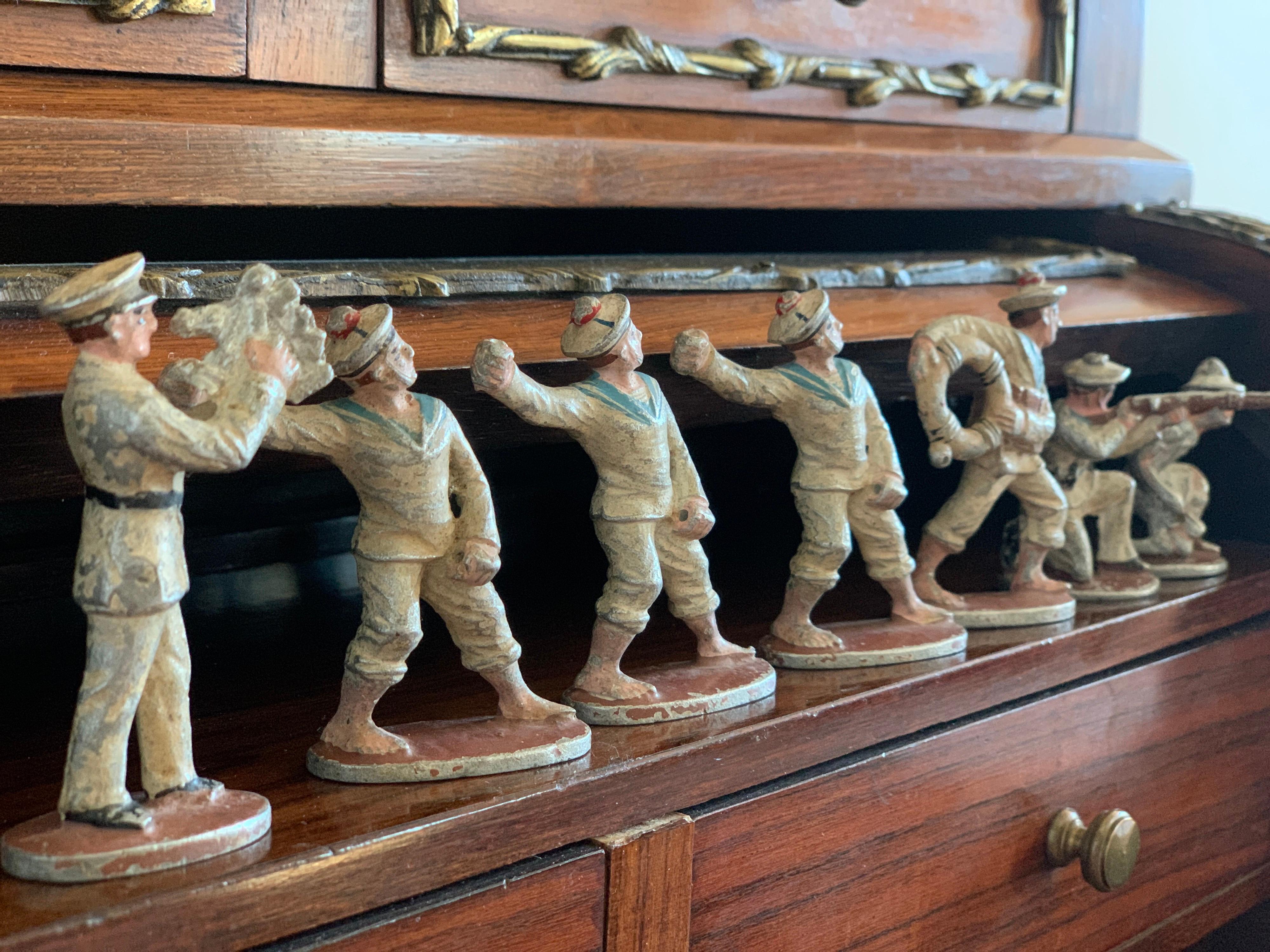 This collection contains seven marine soldiers in various poses with typical uniforms. All figures are hand painted and are standing on their own base. Circa 1940.