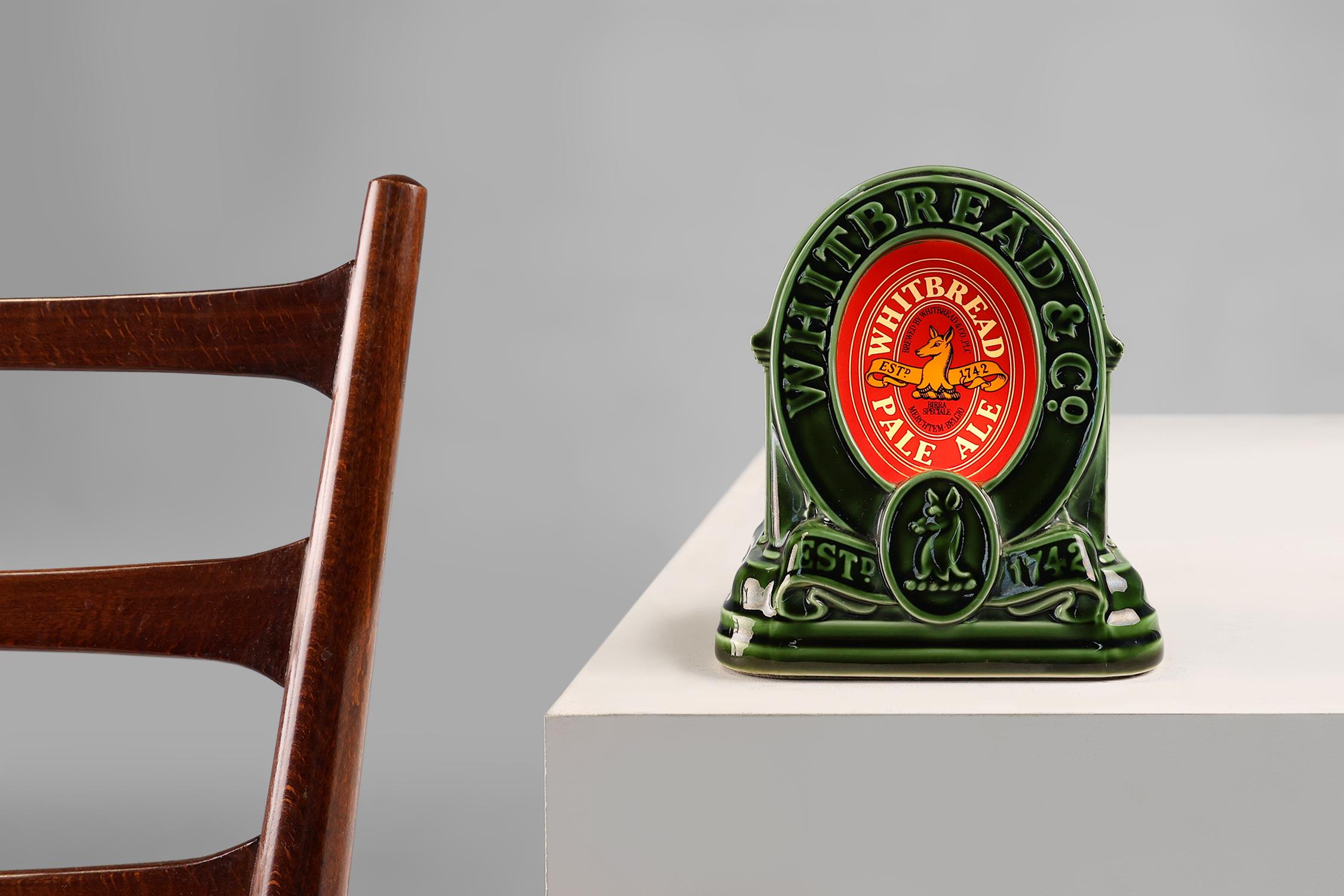 United Kingdom / 1950 / Lamp / Whitbread & Co / ceramic, glass / Mid-century / Vintage

A vintage table lamp from the Whitbreast Pale Ale brewery. In green glazed ceramic with the iconic red Whitbread logo in glass. Designed to look like a bar top. 