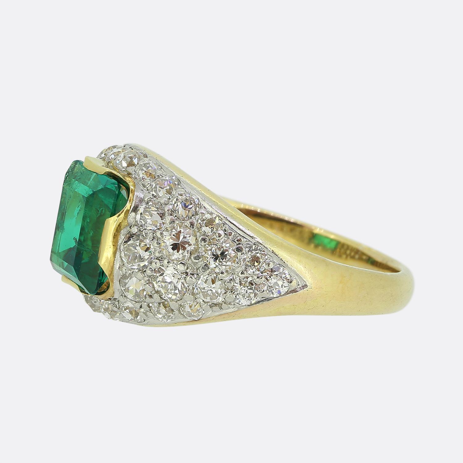 Here we have a truly wonderful vintage emerald and diamond ring. The ring features a highly desirable rich green Colombian emerald that sits in a raised mount and is surrounded by bright white old cut diamonds in a Bombe style. It is exceptionally
