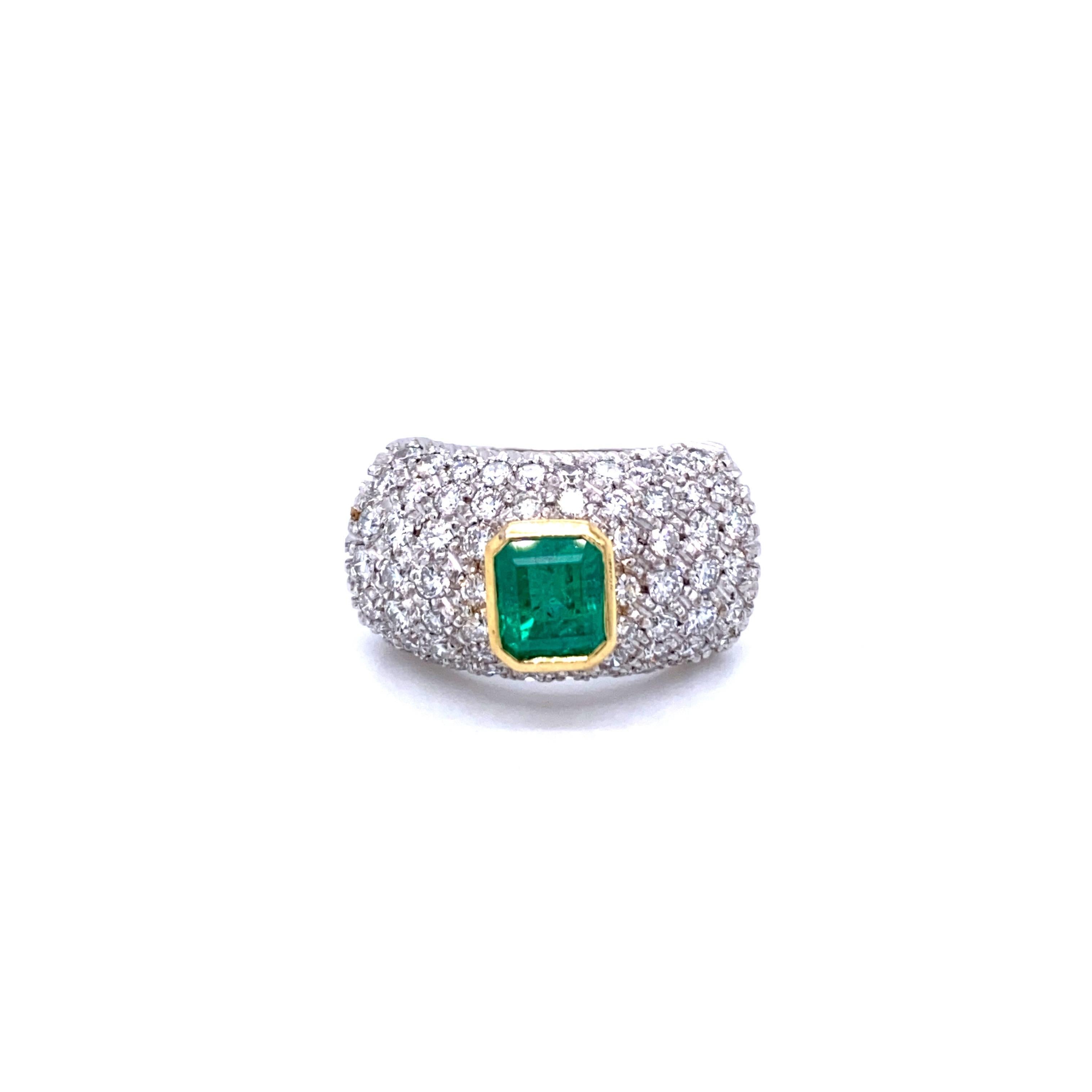 A beautiful emerald ring dated 1960, handmade in Italy in 18k white Gold showcasing a Natural Colombian emerald cut Emerald in the center weighing approx. 1.20 carat and surrounded by 2.00 carat of diamonds graded G color Vvs clarity pave