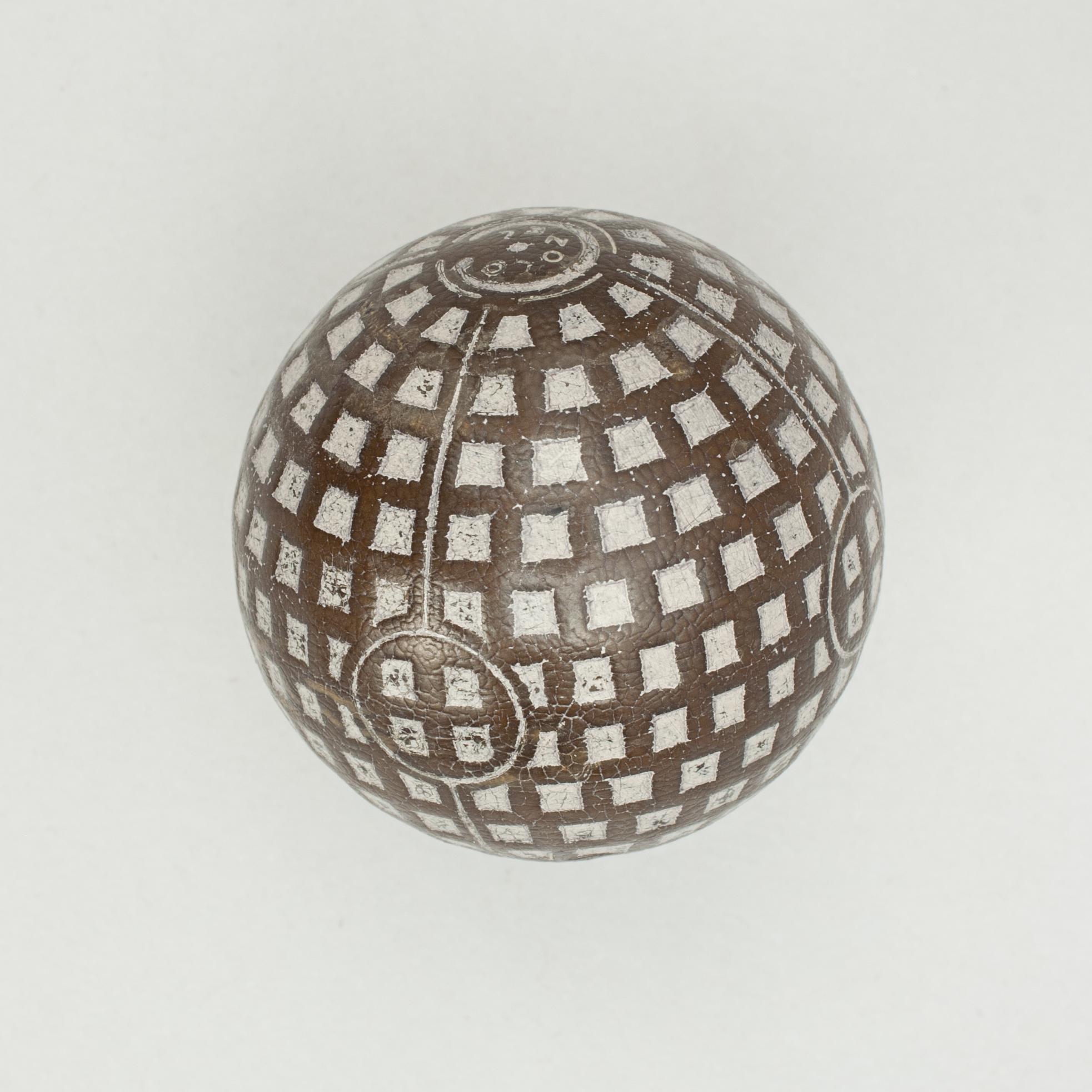 Unusual 'Colonel' mesh pattern golf ball.
A very unusual Trapezium patterned 1920s 'Colonel' mesh rubber core golf ball in used condition. The pattern is made up of Trapeziums going around the ball making squares or mesh patterns. The ball is