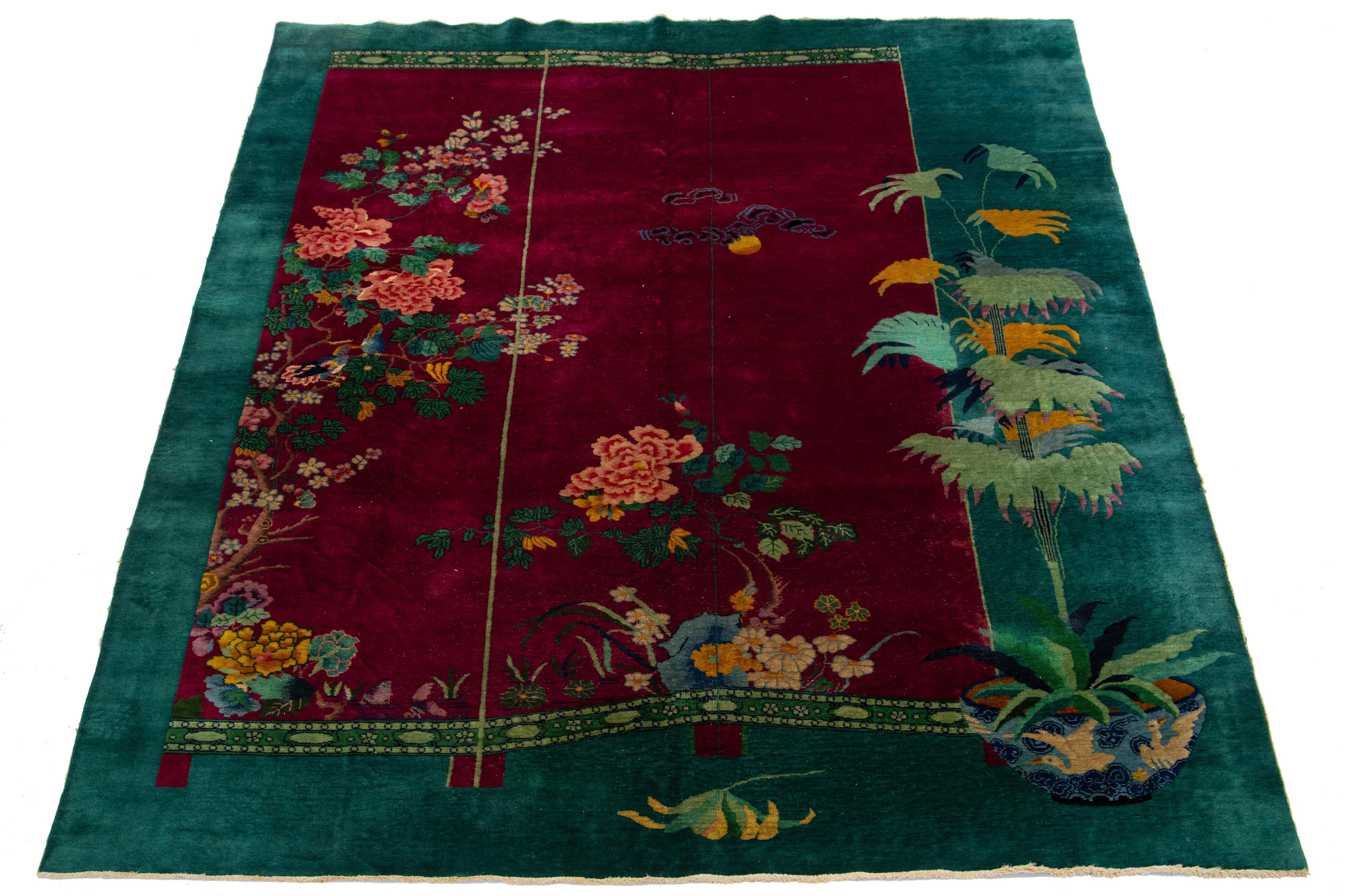 A beautiful vintage Chinese Art Deco hand knotted wool rug with a red field-wide, green frame and multi-color accents in all-over Chinese floral design.

This rug measures: 10'10
