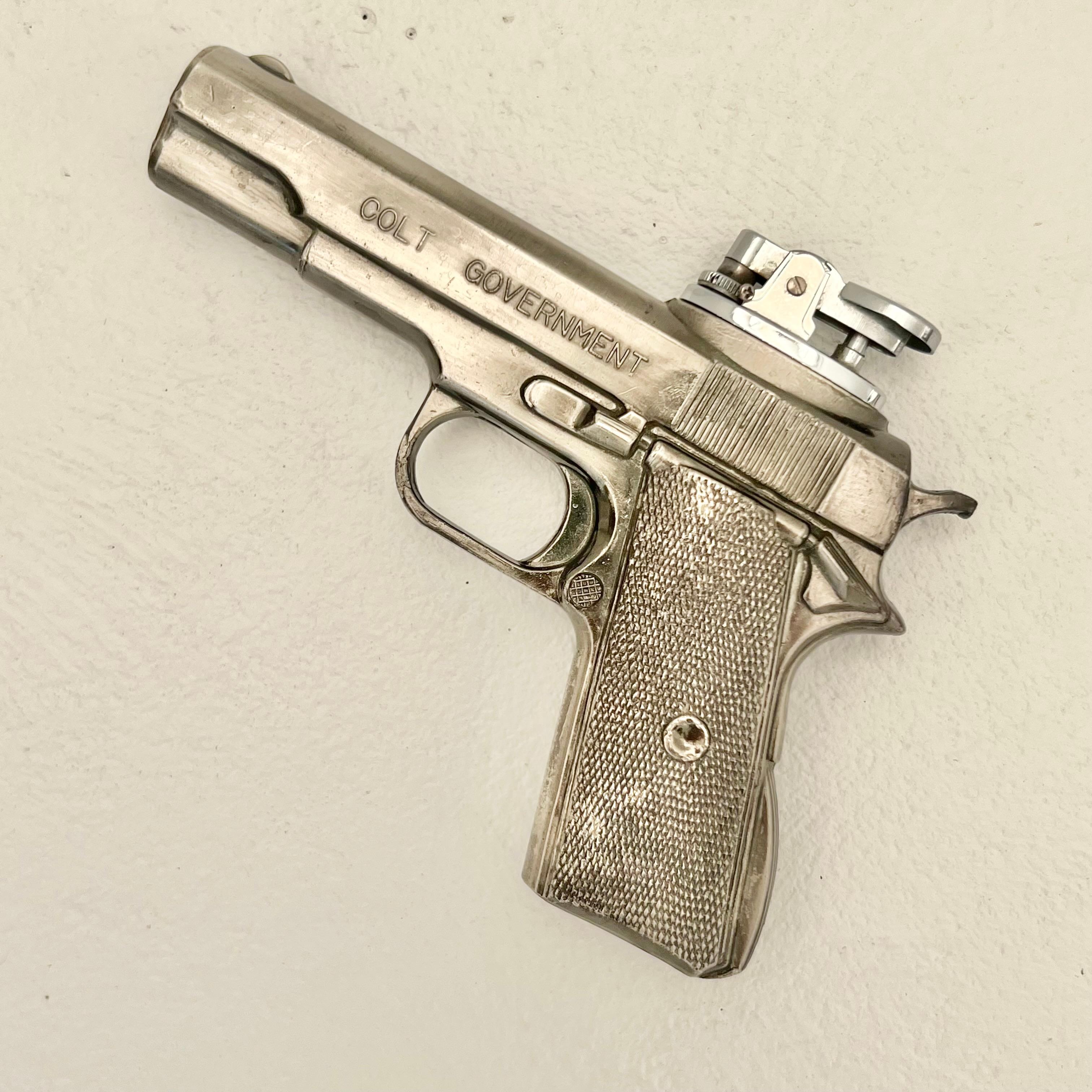 Vintage table lighter in the shape of a Colt handgun. Works perfectly. Modeled after a Colt Government handgun. Made of metal in Japan. Good working condition and fun object. Sold out of Comoy's of London. 

